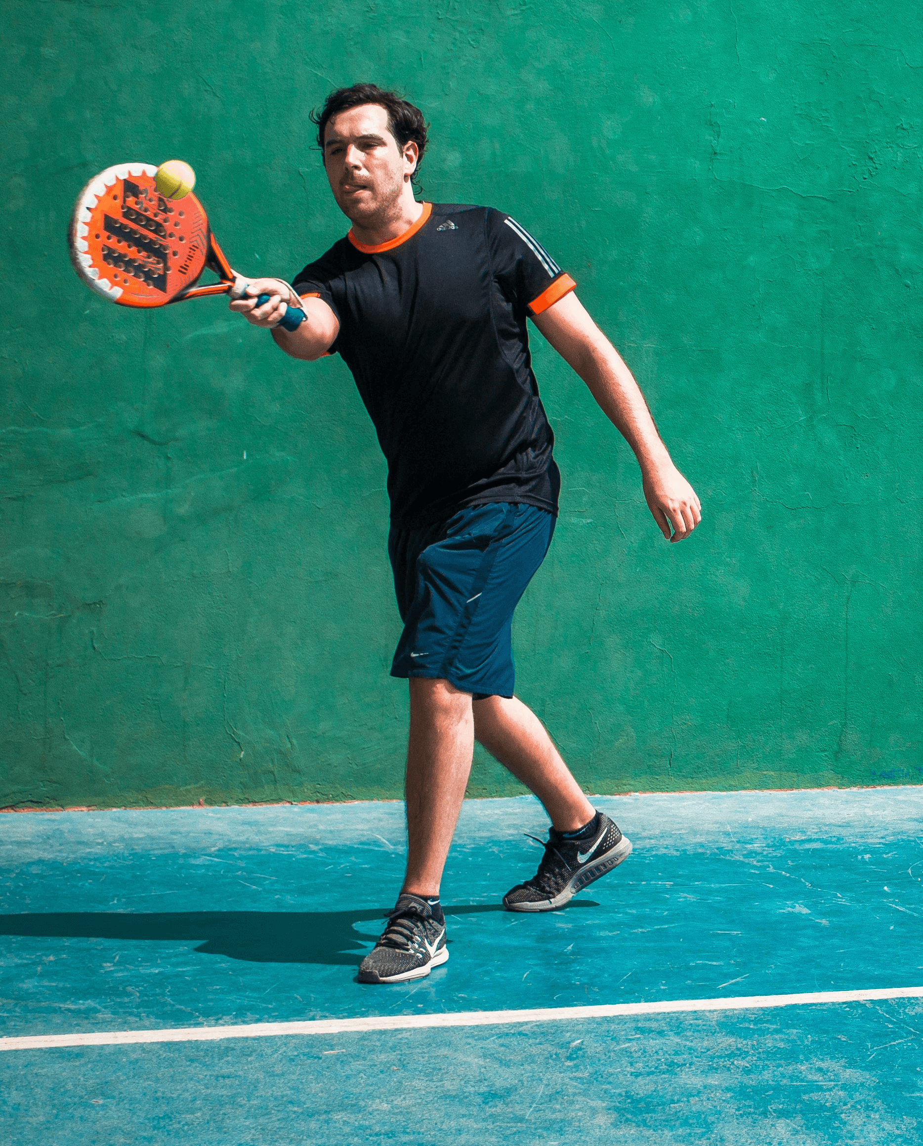 a man holding a tennis racquet on a tennis court