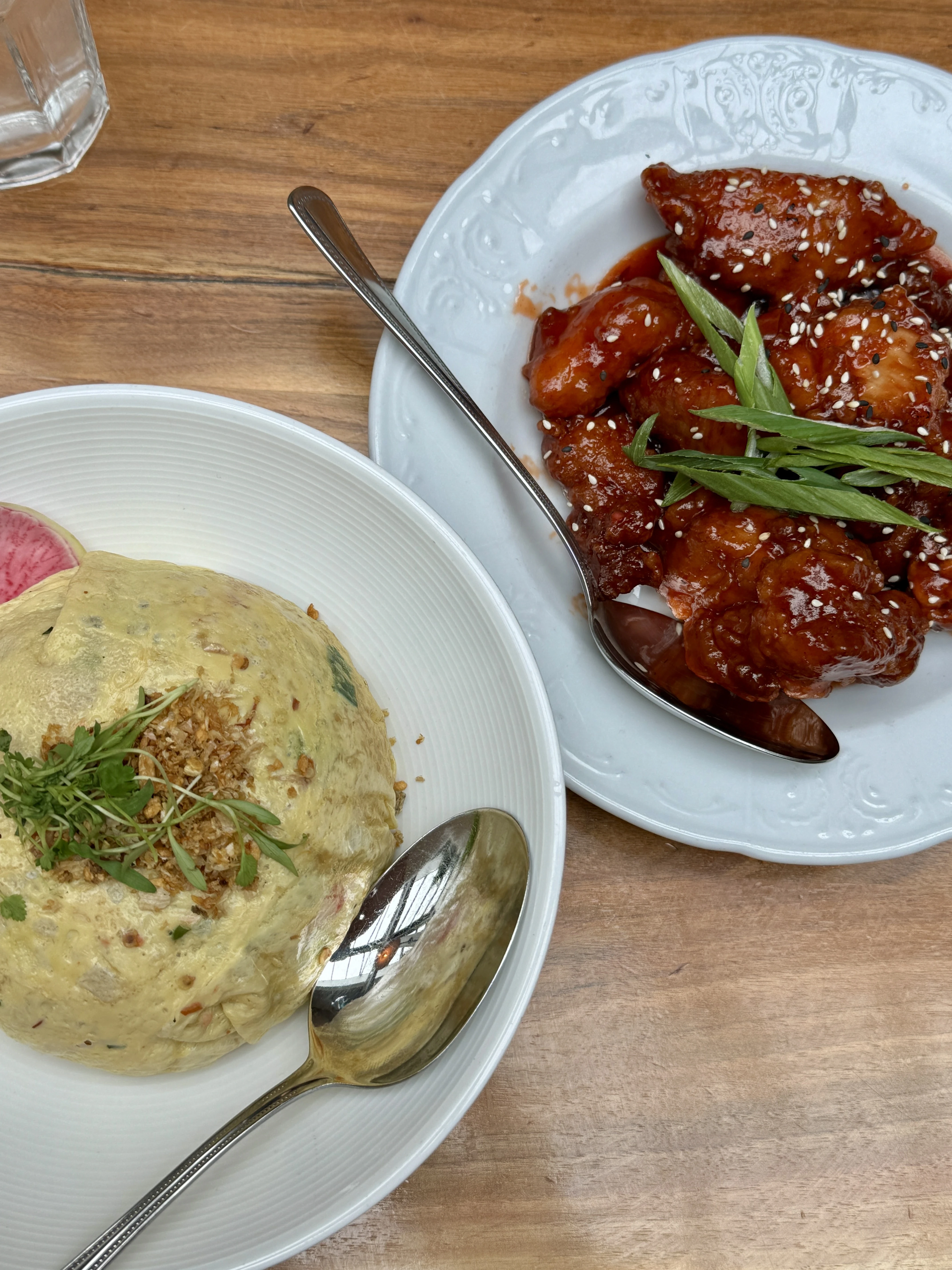 asian-fusion dishes from brewery bhavana on white plates on a wooden table in raleigh nc