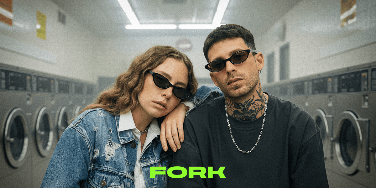 Two people wearing stylish FORK sunglasses in a laundromat, showcasing nightlife-inspired fashion by Optimax Eyewear Group.