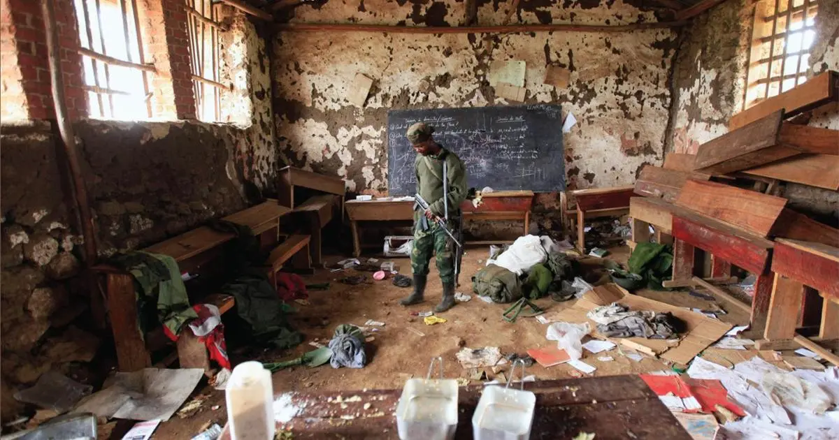 an empty classroom with wooden desks and windows