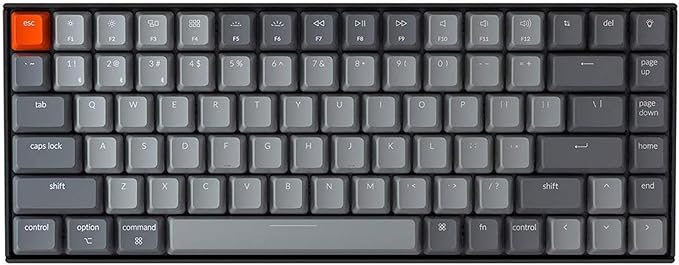 Keychron K2 mechanical keyboard, a compact grey keyboard with an orange escape key, shown from above.