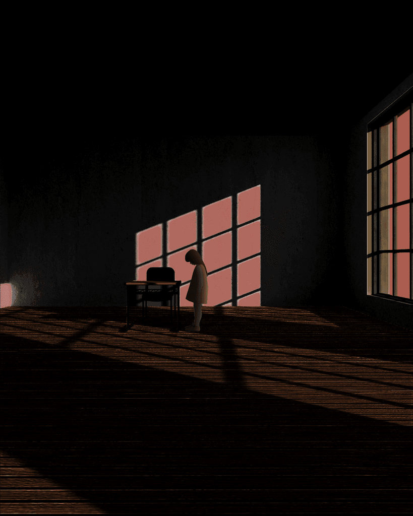 A person sitting at a desk in a dark room, engrossed in work.
