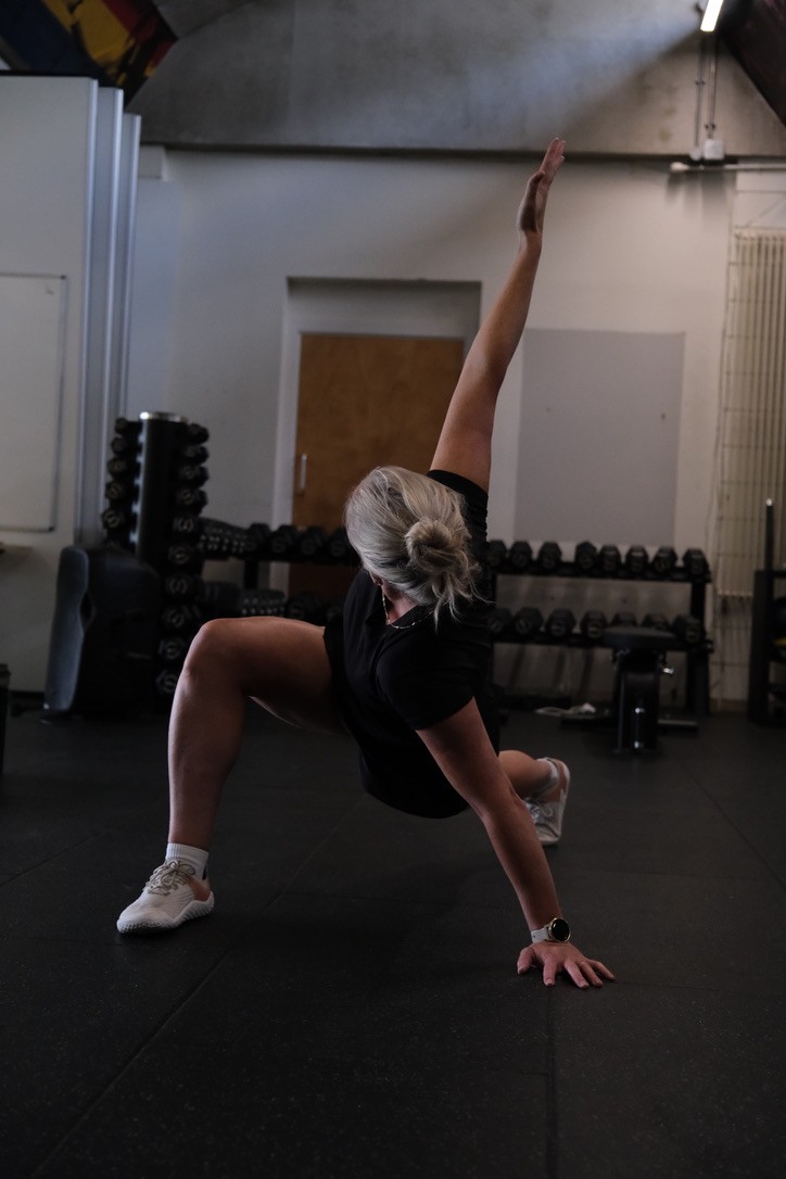 Personal trainer helping client with fitness