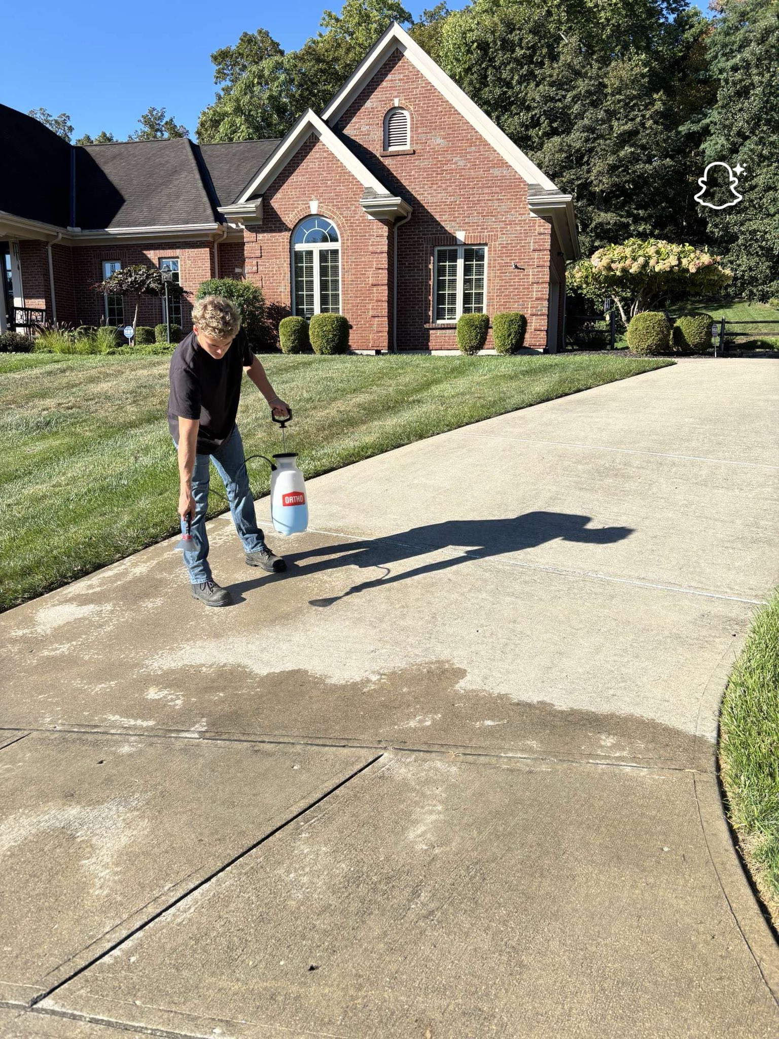 man in gray hoodie and blue denim jeans standing on brown wooden parquet flooring