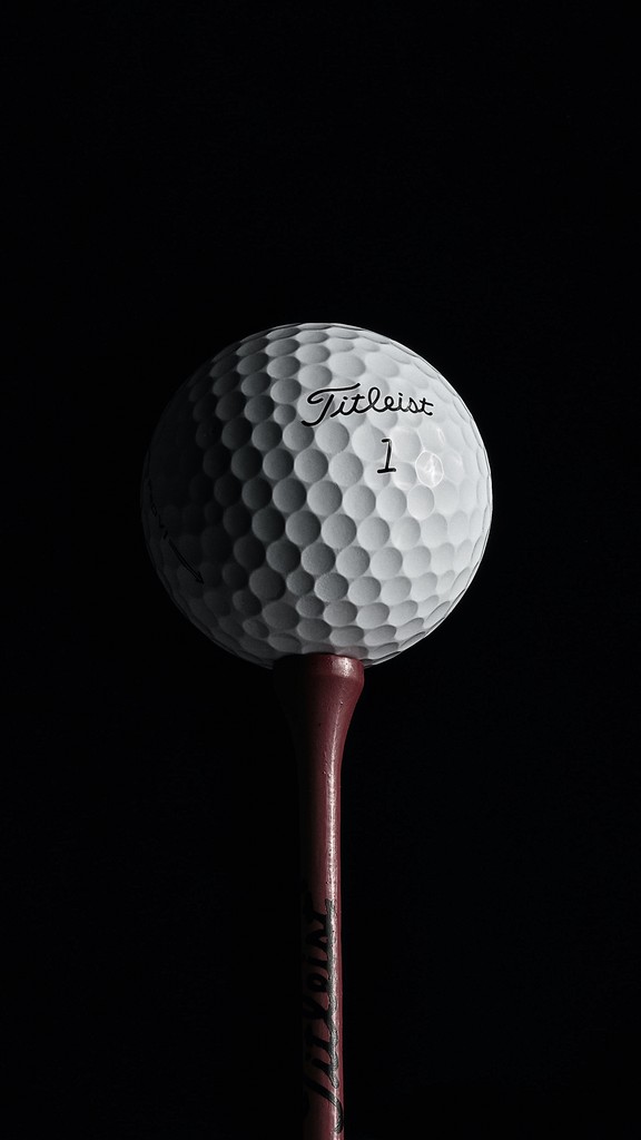 Golf ball in black background