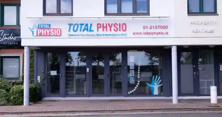 The front of the Total Physio building at Sandyford Office Park, with the Total Physio sign above the glass doors.