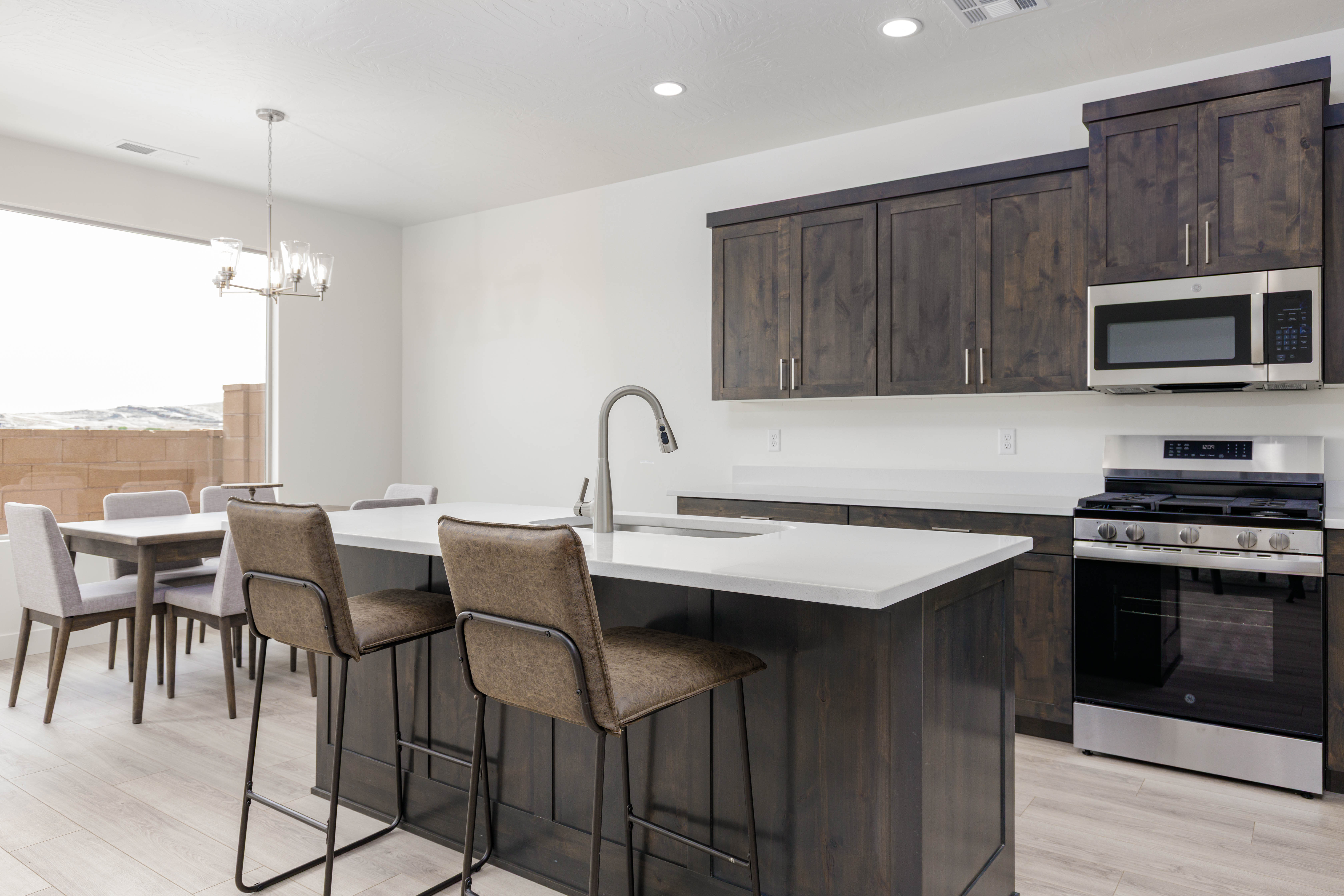 Bright kitchen space featuring dark cabinets and functional design in Hurricane Utah new construction home.