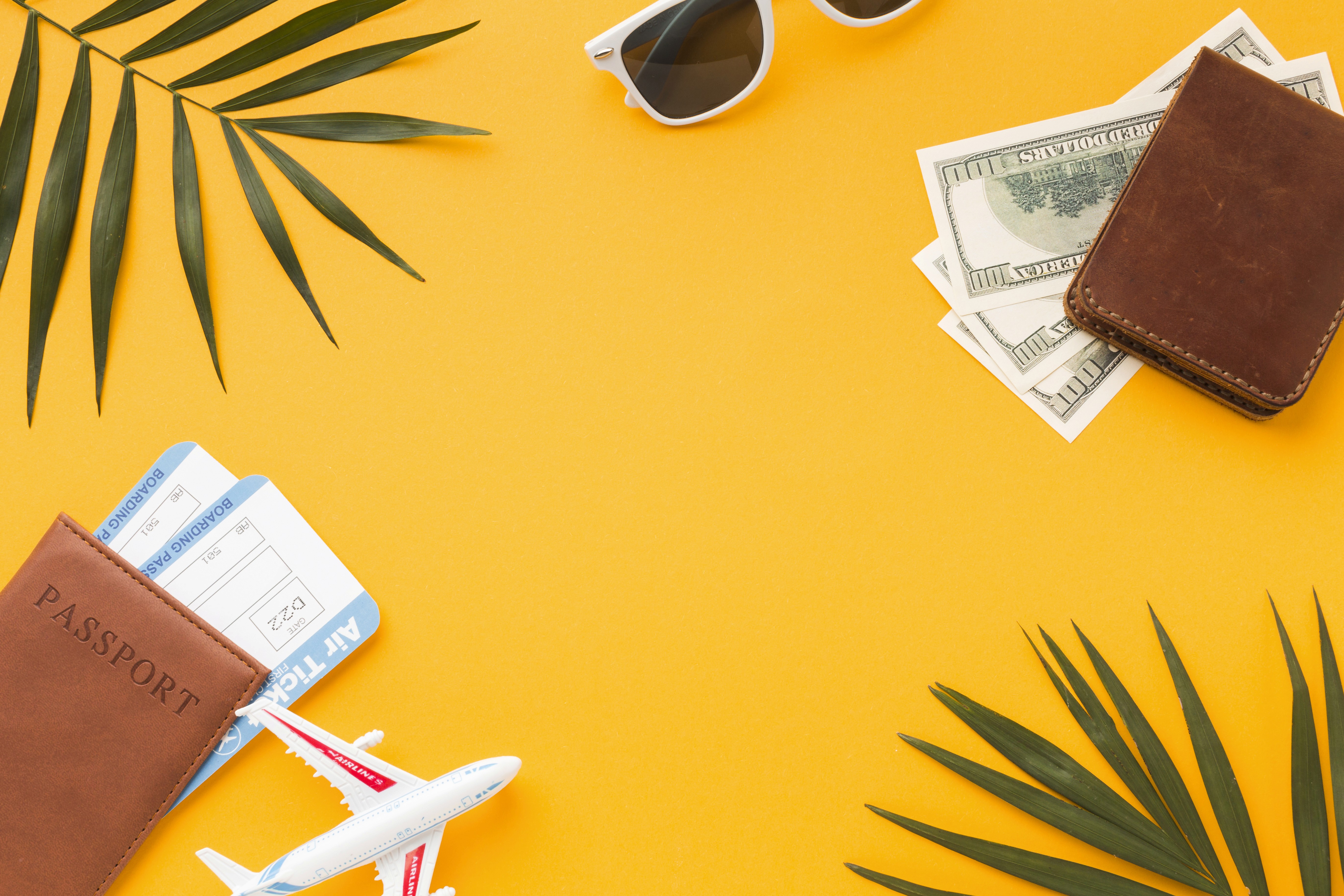Landscape with a vineyard in rows leading to a building with a tower, rolling hills in the distance.