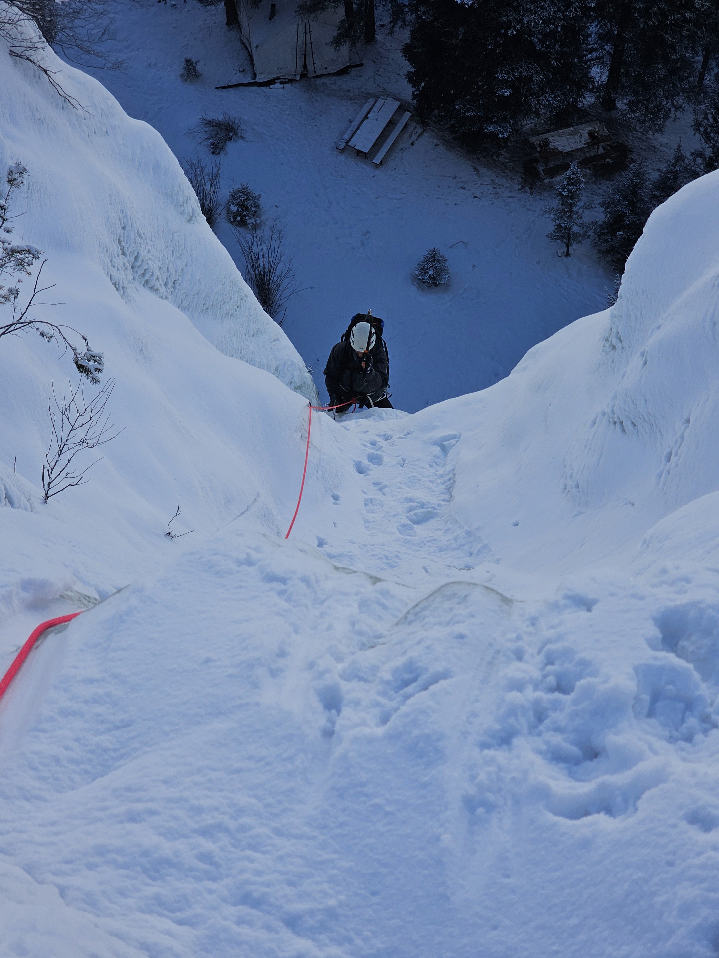 Ice climber focuses on swinging their ice tool in the Lake City Ice Park