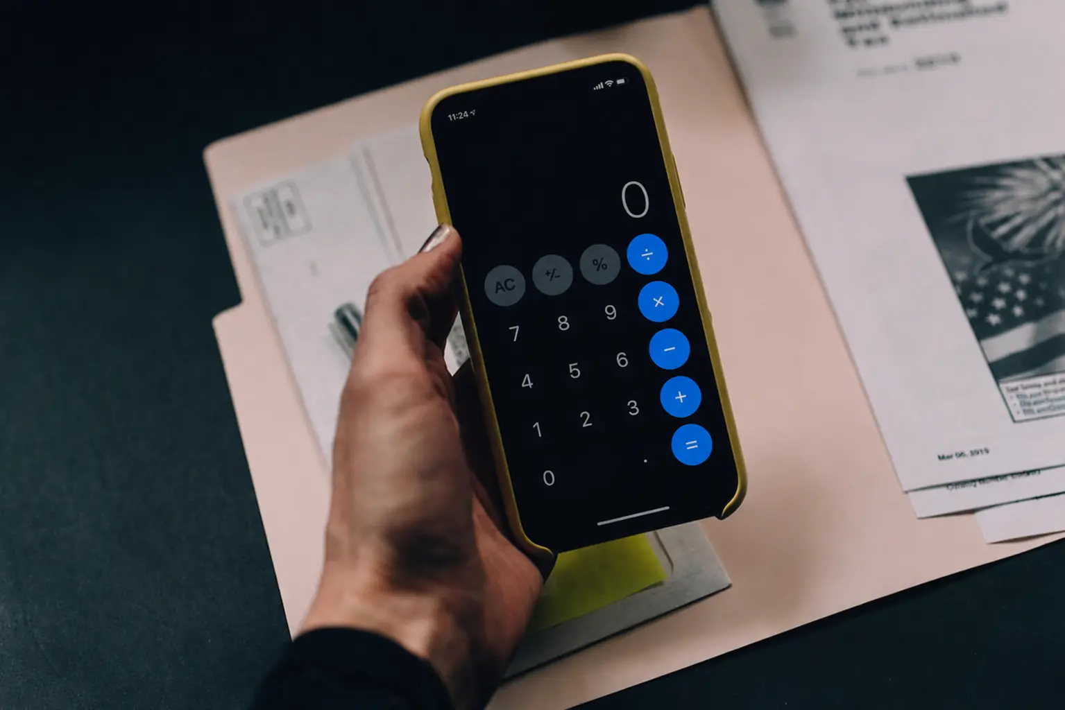 Female hand with mobile calculator iphone