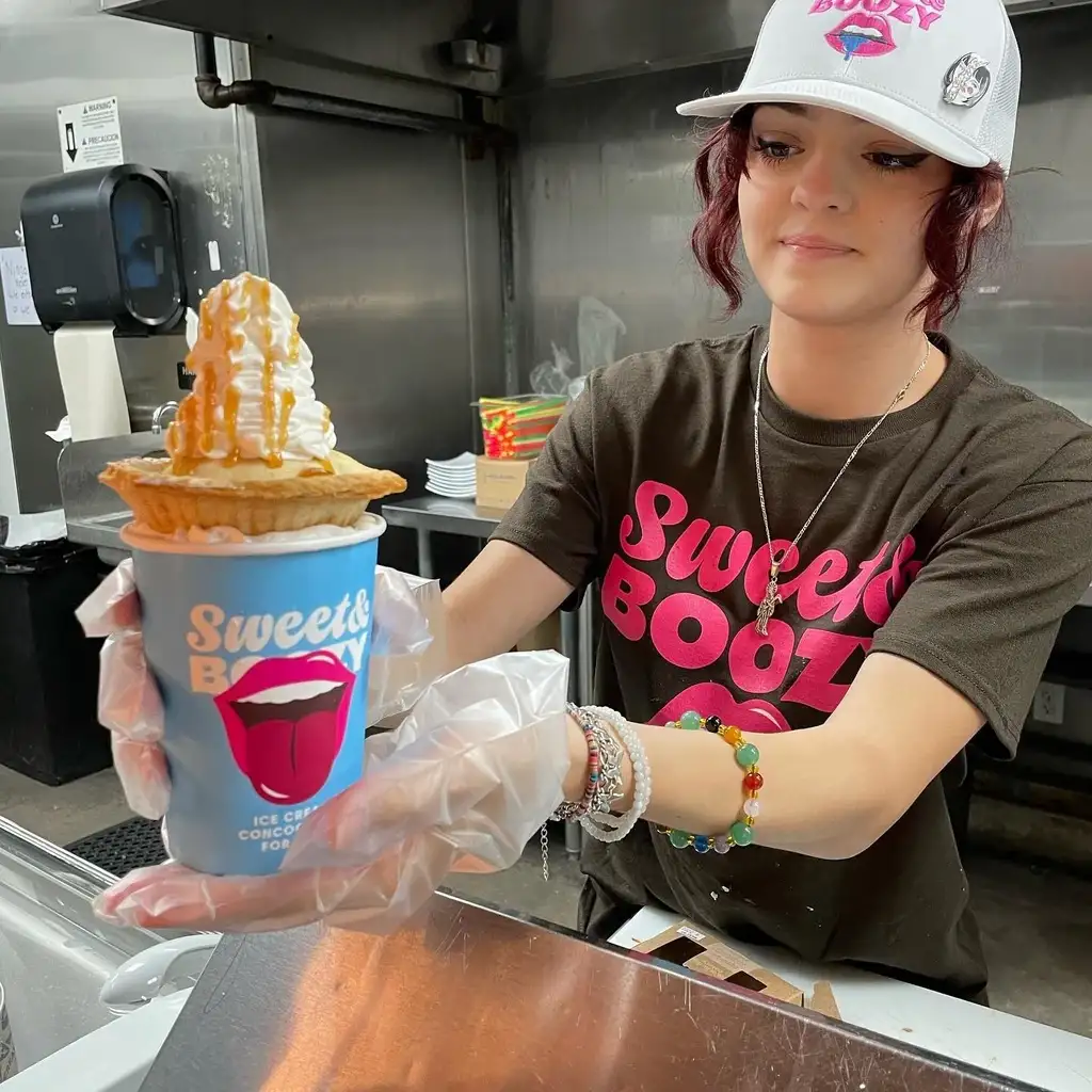 Sweet & Boozy worker handing out thundercup ice cream to customer