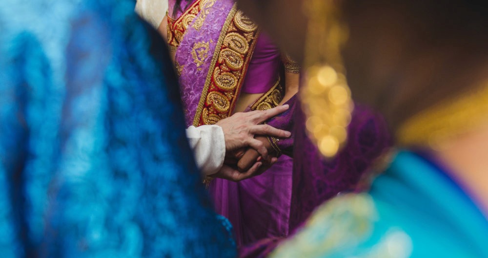 A close-up view of several colorful fabrics, featuring intricate patterns and textures in vibrant hues.