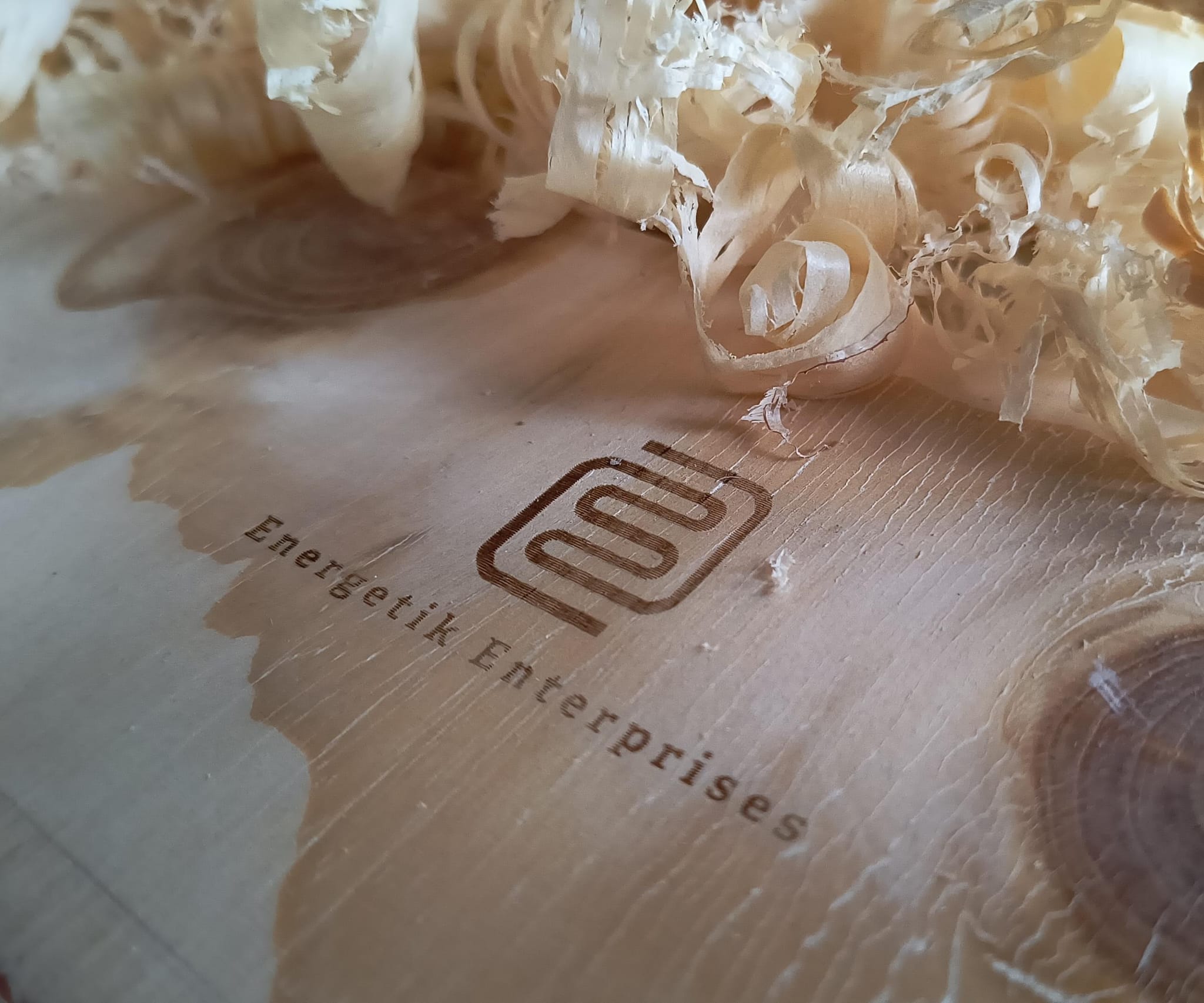 A young woman with wet hair, leaning back in a bath with her eyes closed. The sunlight reflects off the water, creating a serene and tranquil atmosphere.