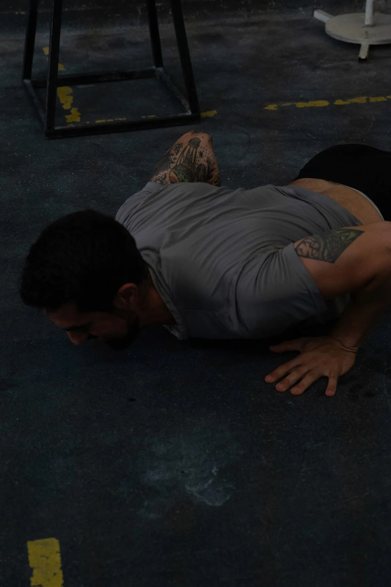 Large house with a wrap-around balcony overlooking a lit pool and deck at night.
