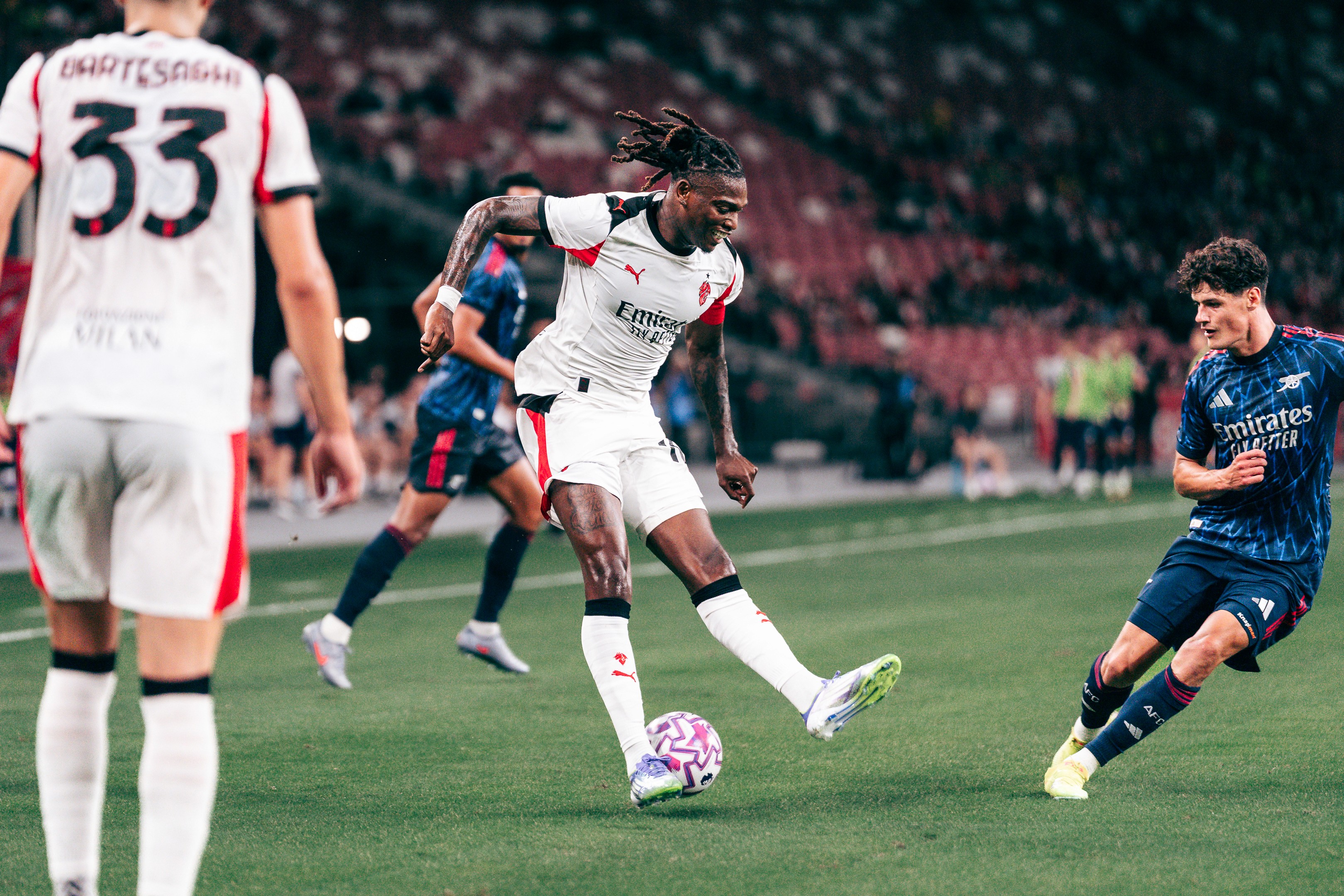 Rafael Leão dribbles during a match between Arsenal and A.C. Milan at the National Stadium in Singapore for the Singapore Festival of Football 2025