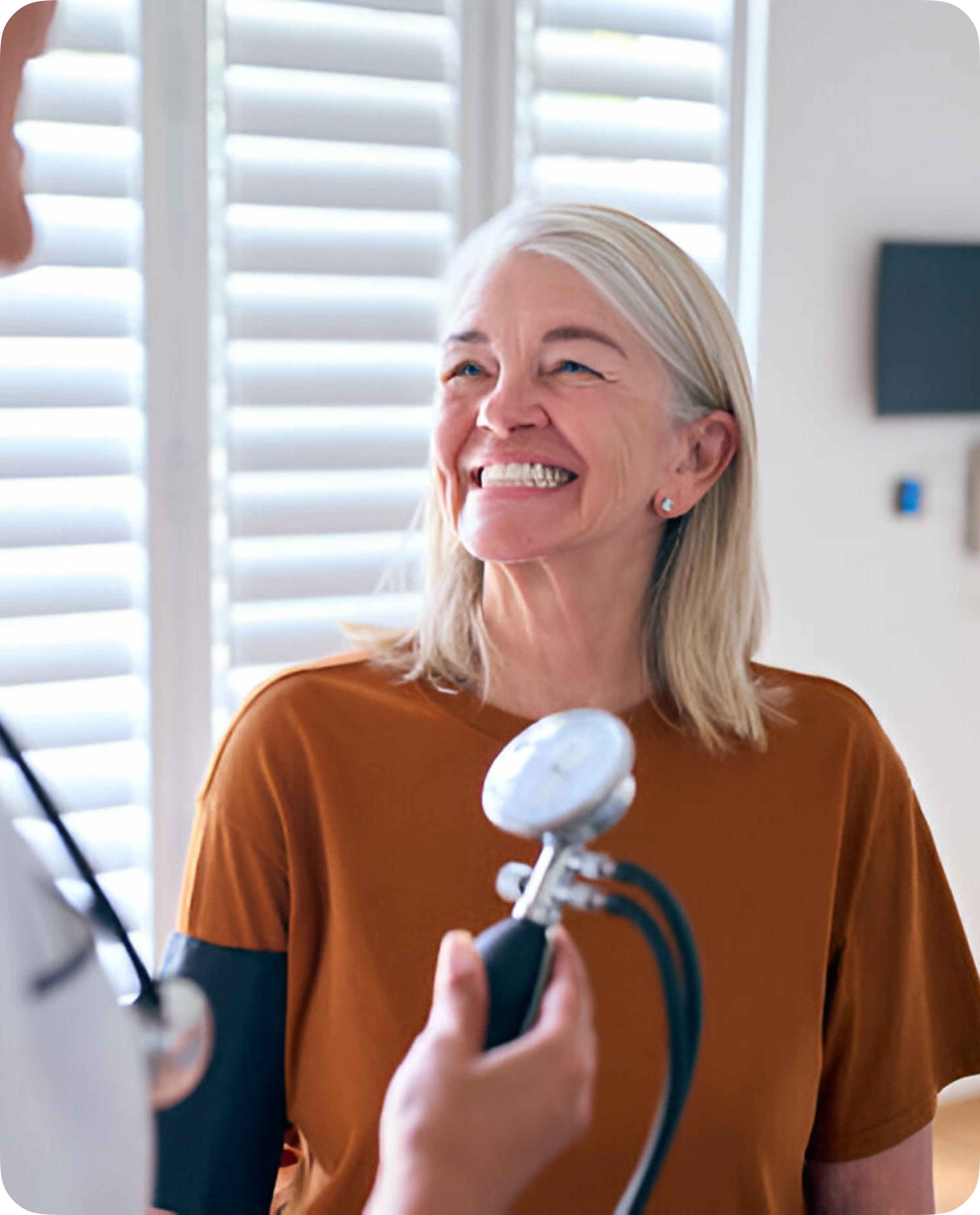 Old woman laughing with her doctor