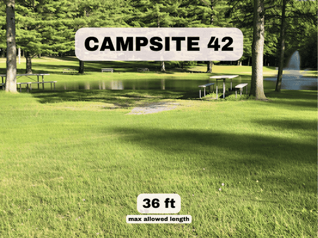Campsite 42 at Pine Hollow Campground, a 36ft pondfront RV site with a picnic table and fountain views