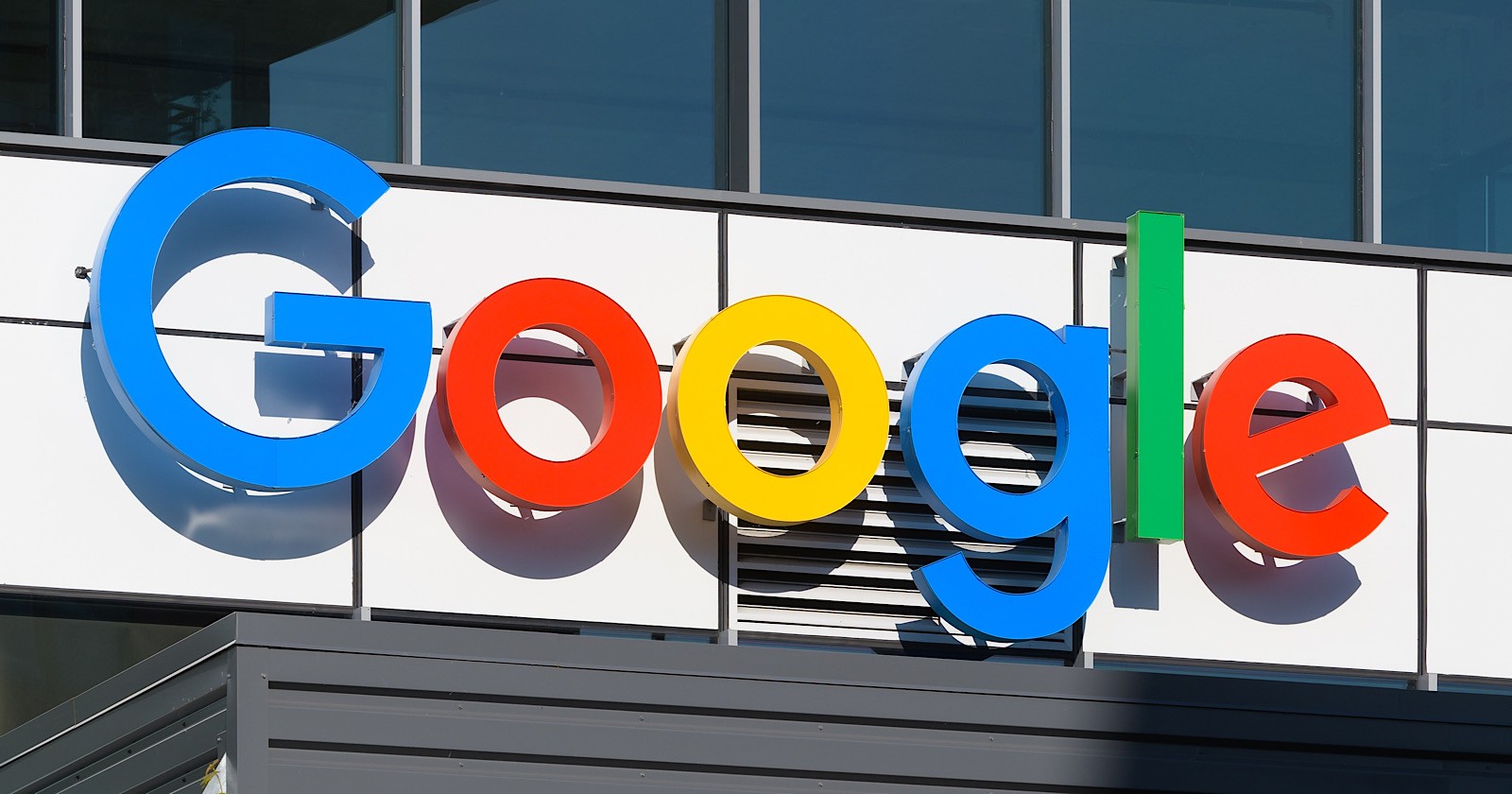 Google logo in bright colors of blue, red, yellow, and green displayed on the surface of a building. 