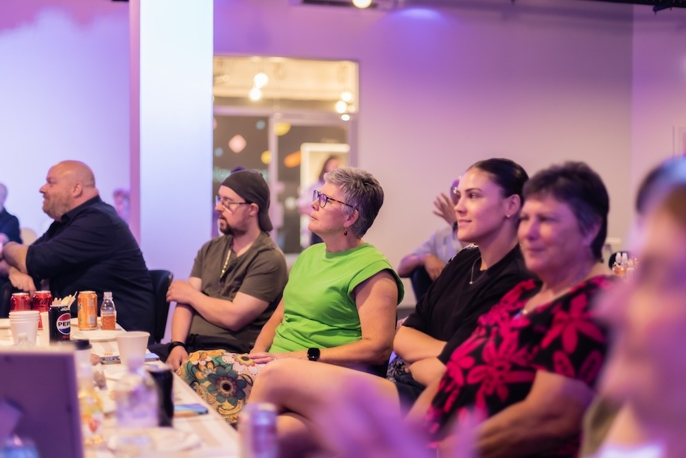 woman in gray coat singing on stage