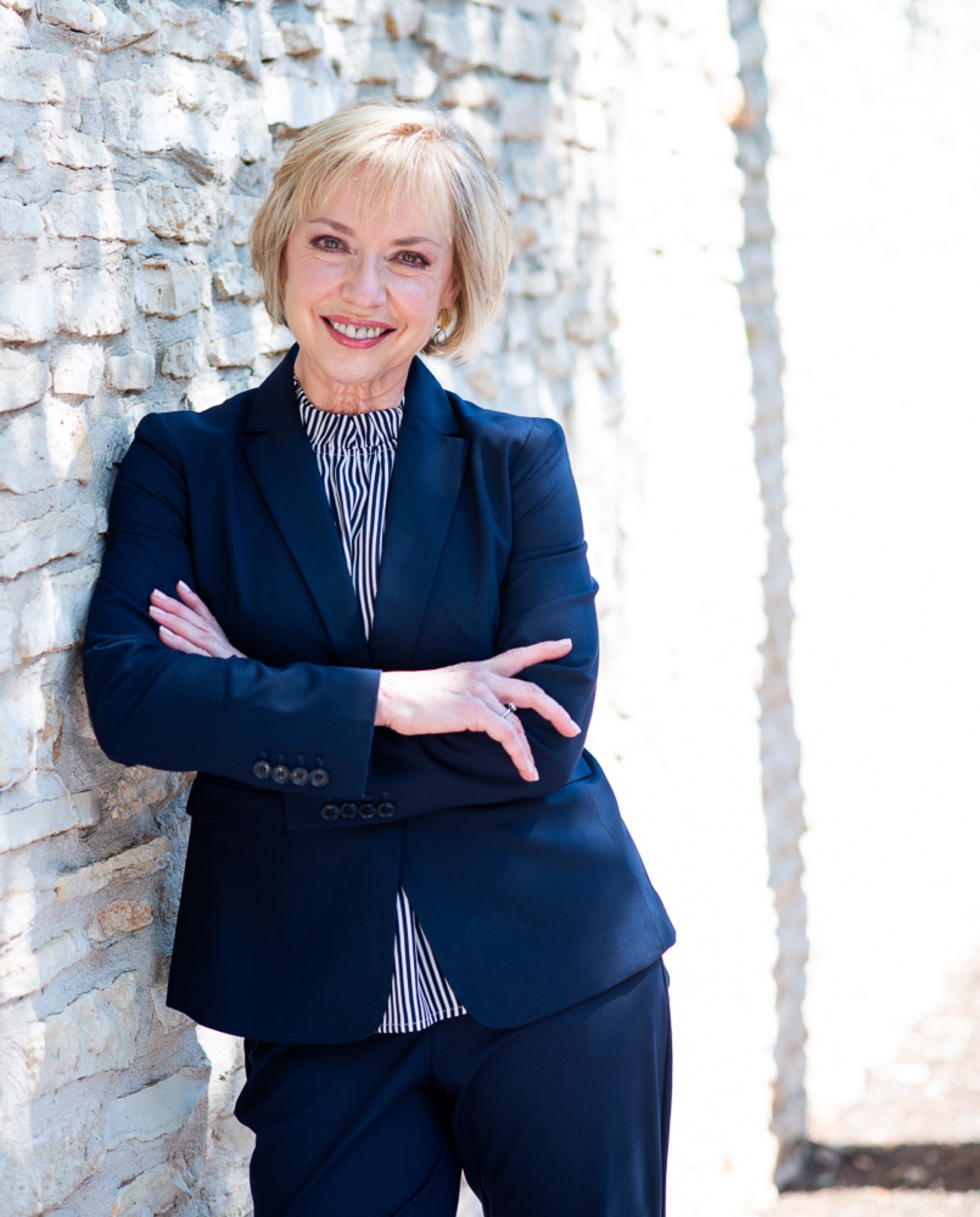 Environmental leadership portrait beside a brick wall