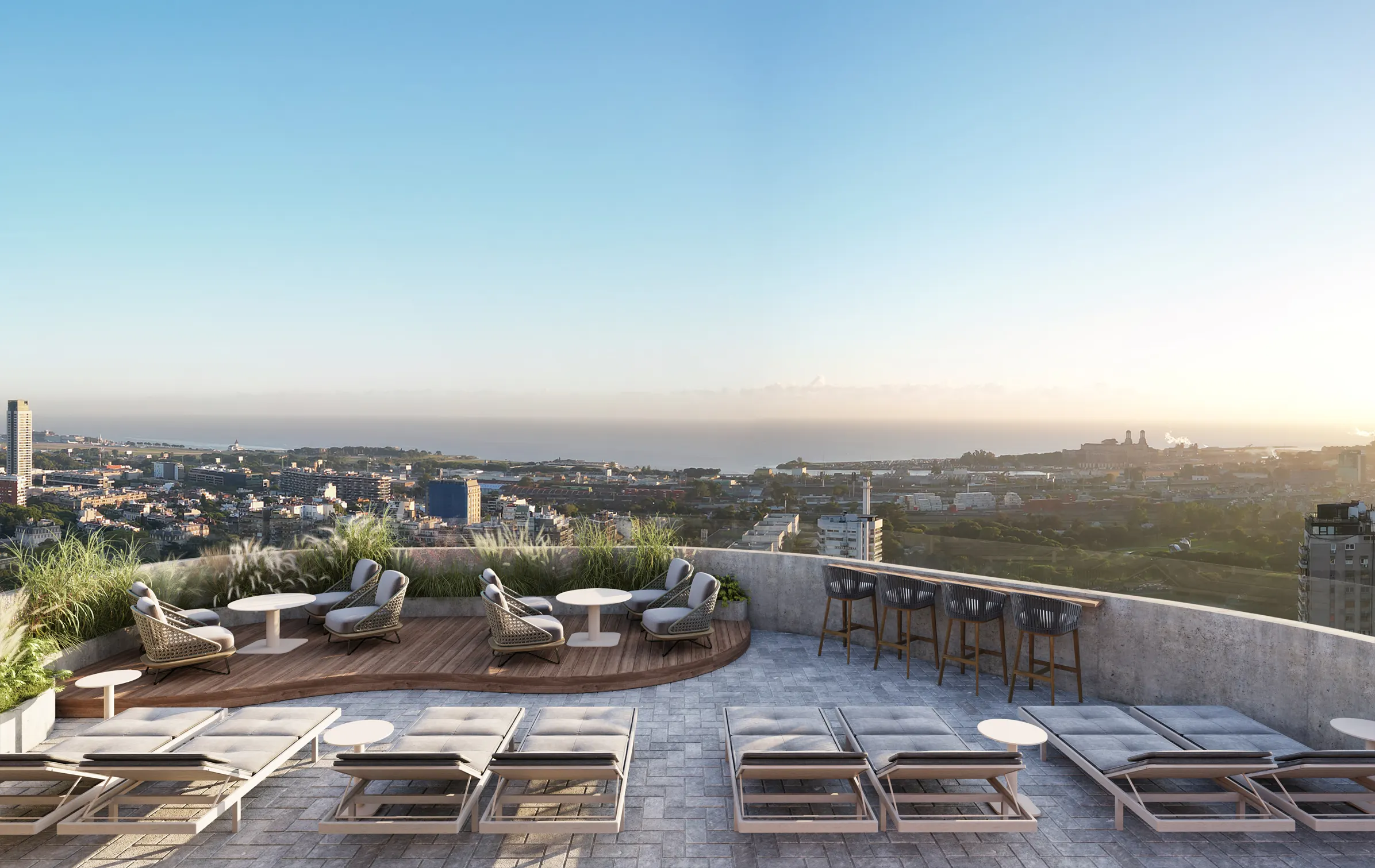 Terraza rooftop con tumbonas, zona de bar y vistas panorámicas al atardecer