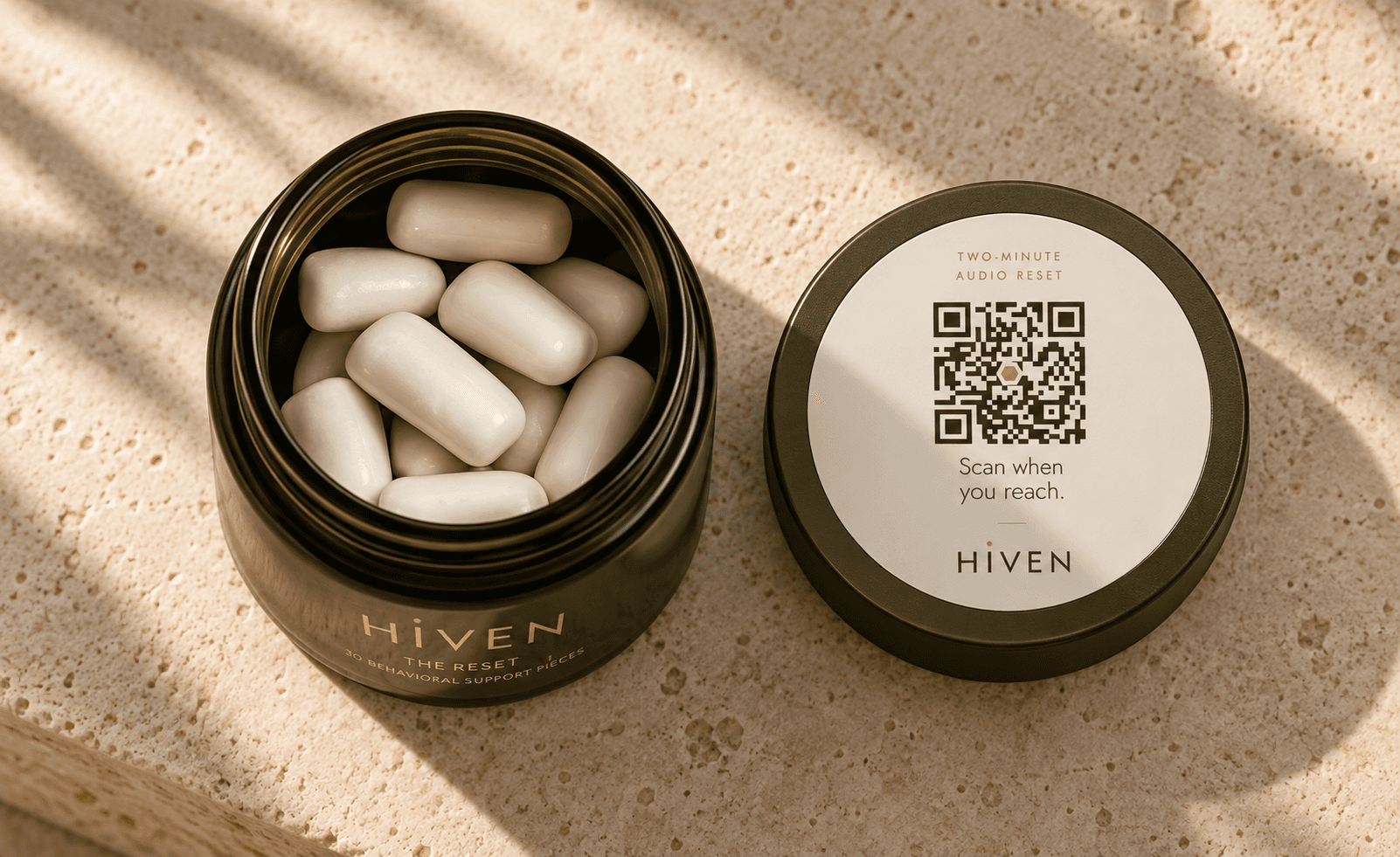 An open Hiven jar filled with gum beside its QR-code lid