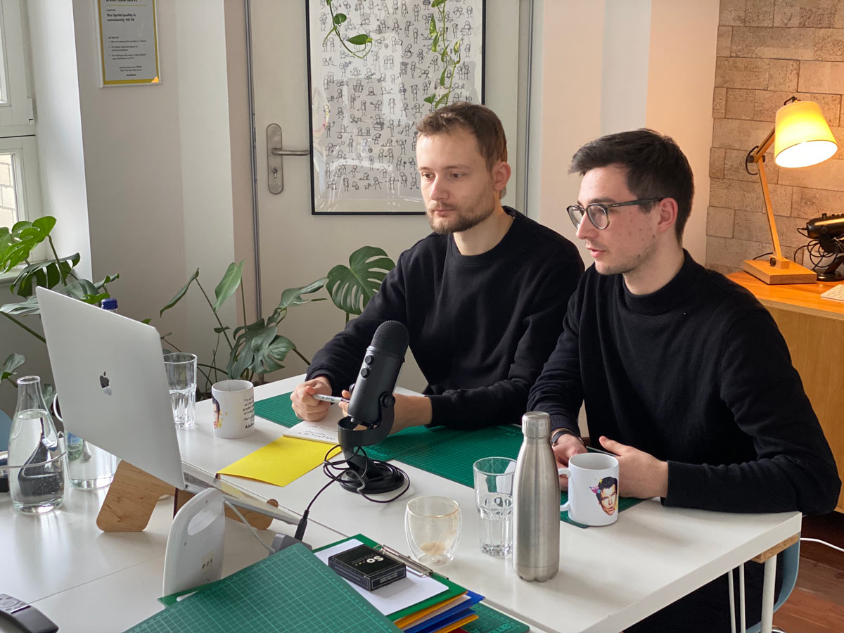 Two facilitators sitting a front of a laptop and taking part in a remote workshop