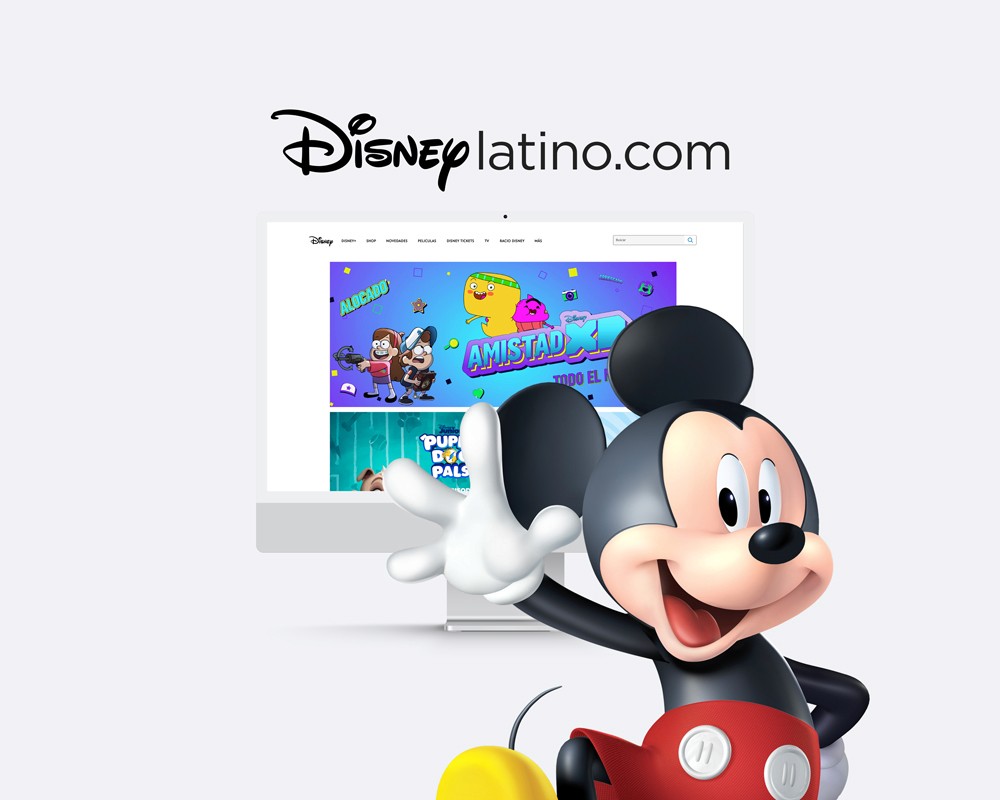 Mickey Mouse saludando frente a una pantalla con el sitio web de Disney Latino, con gráficos coloridos y personajes animados.