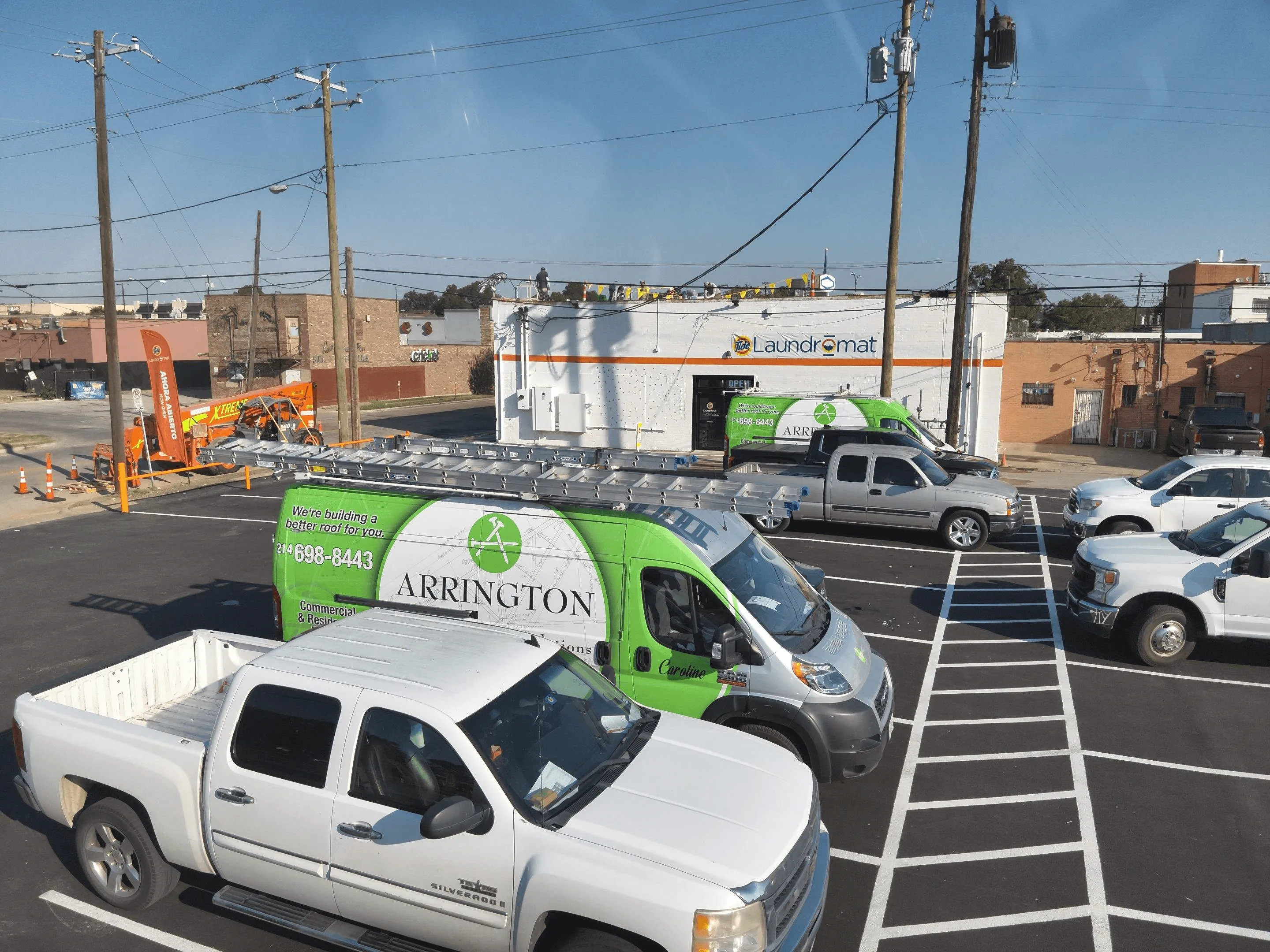 arrington roofing van in front of commercial roofing job site - commercial roof replacement in dallas tx by arrington roofing company