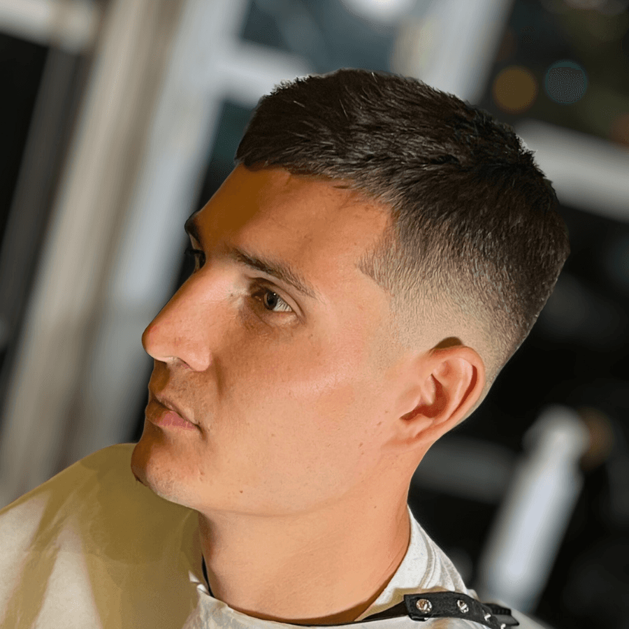 person holding white and gold hair comb