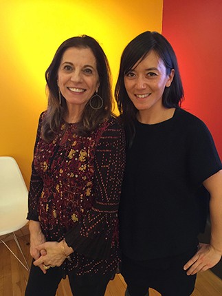 A photo of two people standing in an exhibition room.