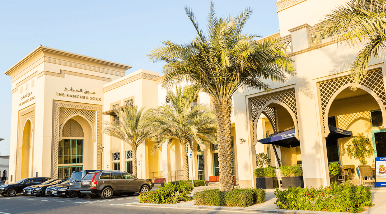 An impressive building with a clock tower, situated in Arabian Ranches.