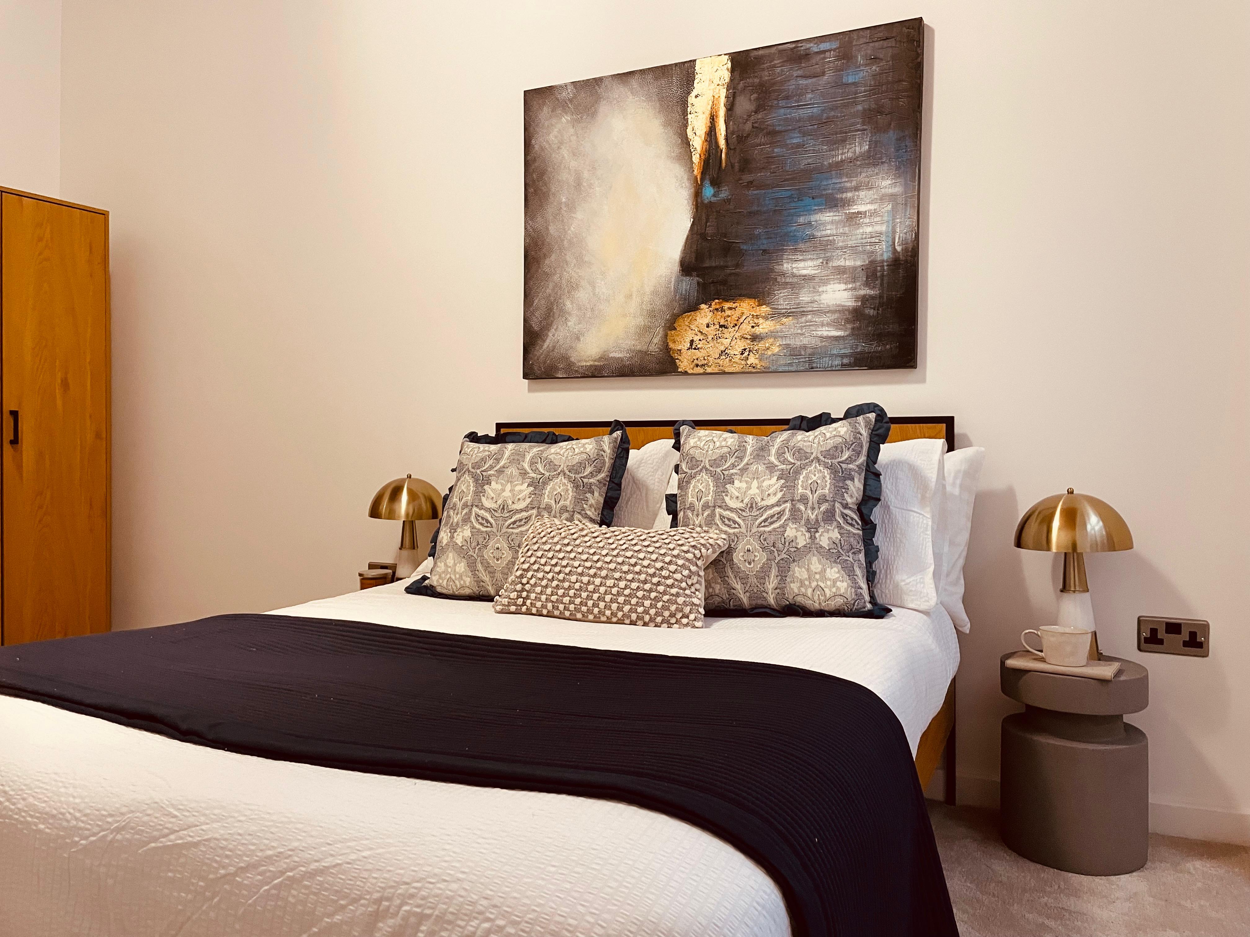 Show home bedroom in Spinning Mill Manchester with graphic artwork and textured soft furnishings