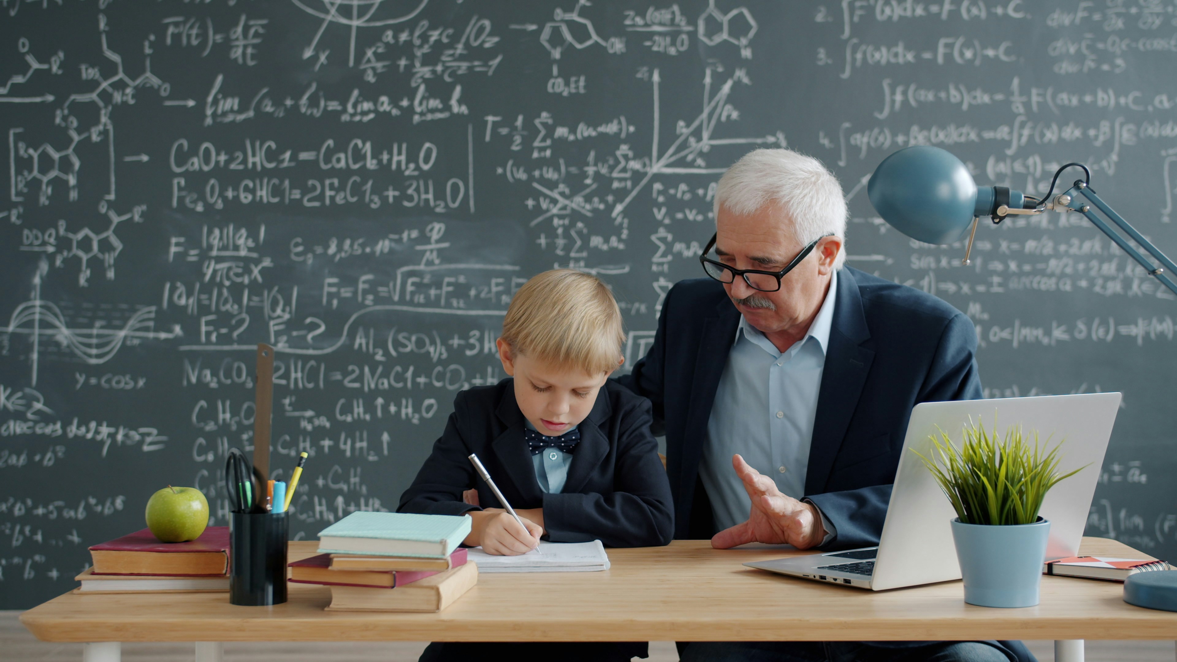 Personalized AI Learning shown as a teacher helps a young student work through assignments at a desk with books and a laptop.