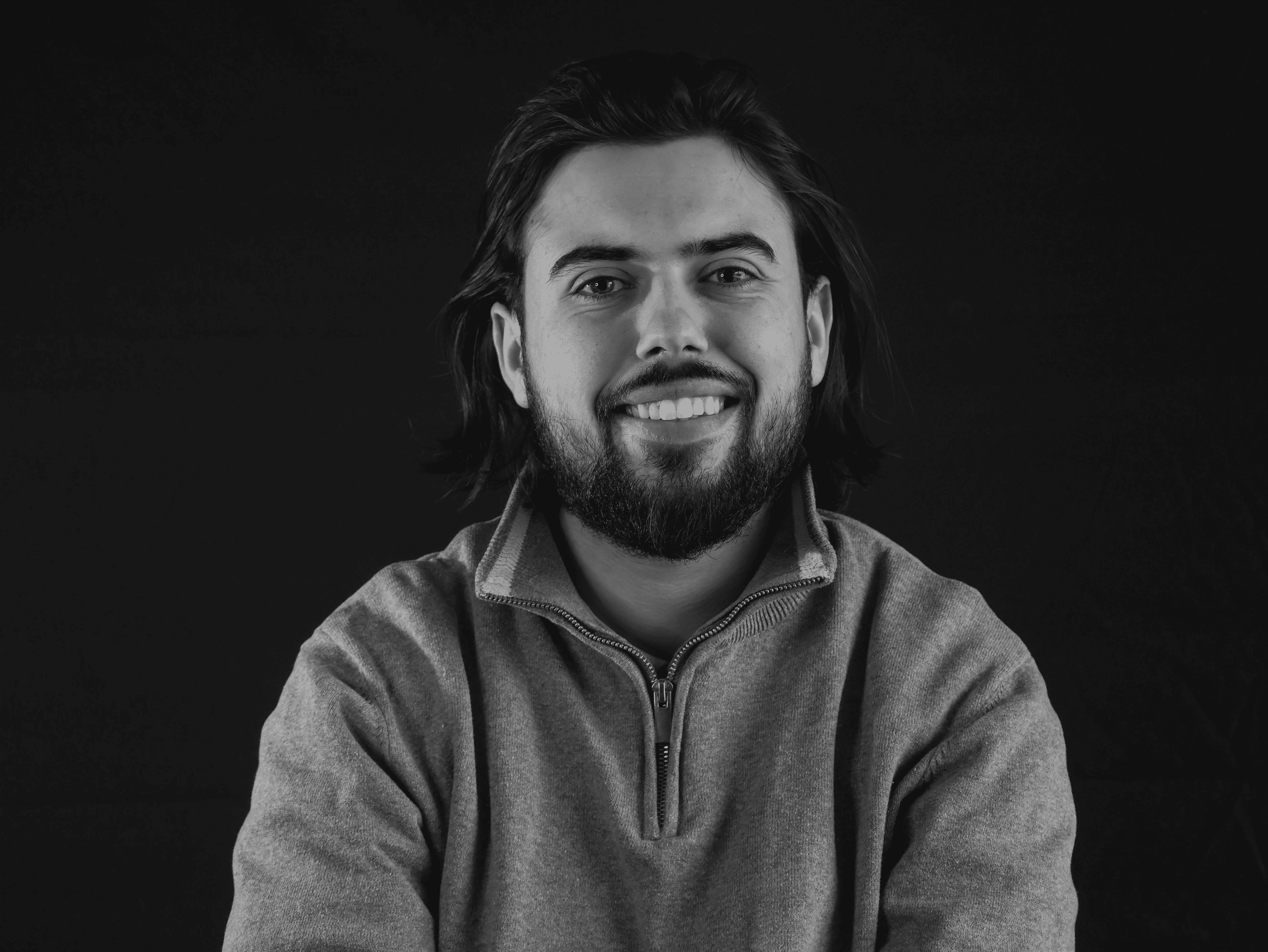 Black and white portrait of a man with a beard and glasses