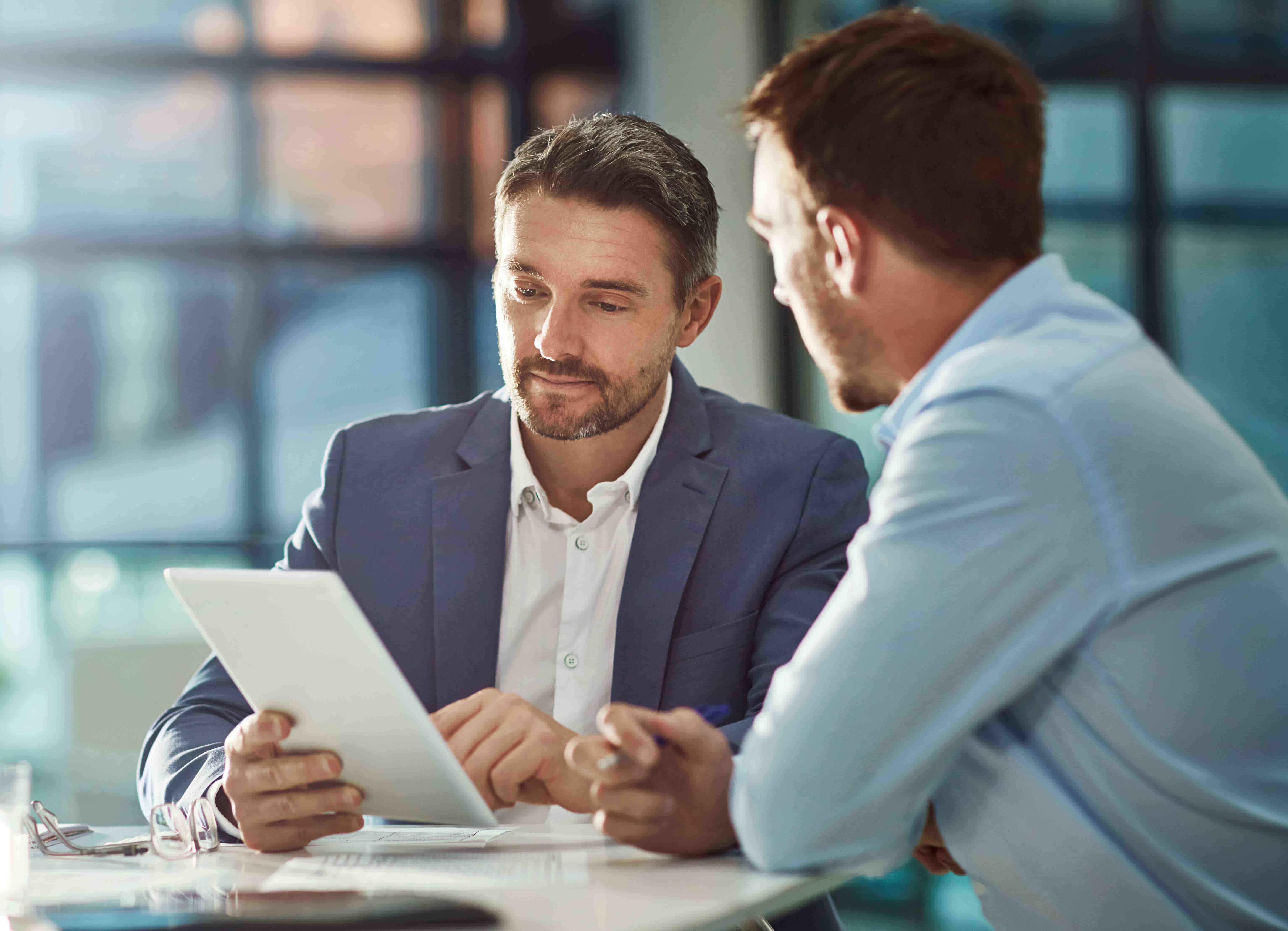 A young man looking toward the horizon in an office.