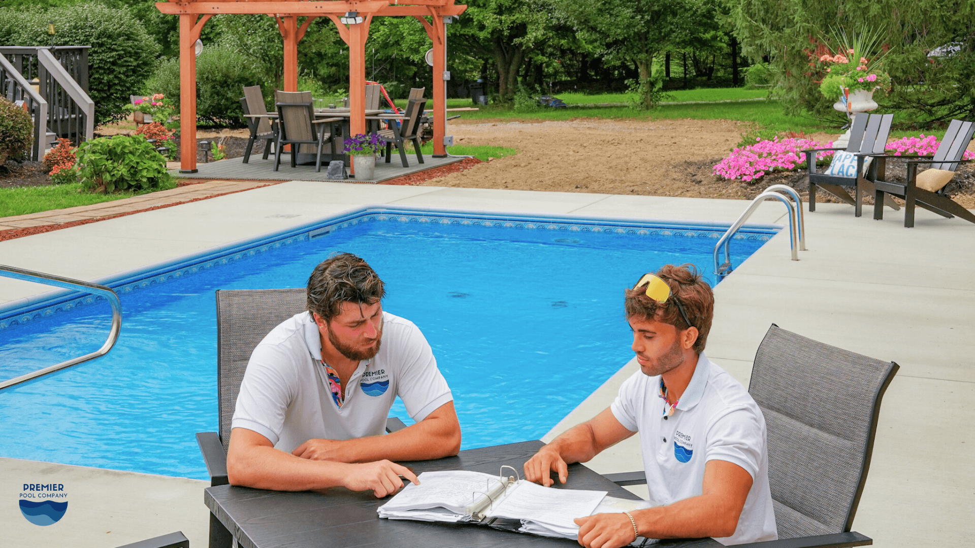 Homeowners reviewing a vinyl liner inground pool quote and budgeting for contingencies, decking, and financing options