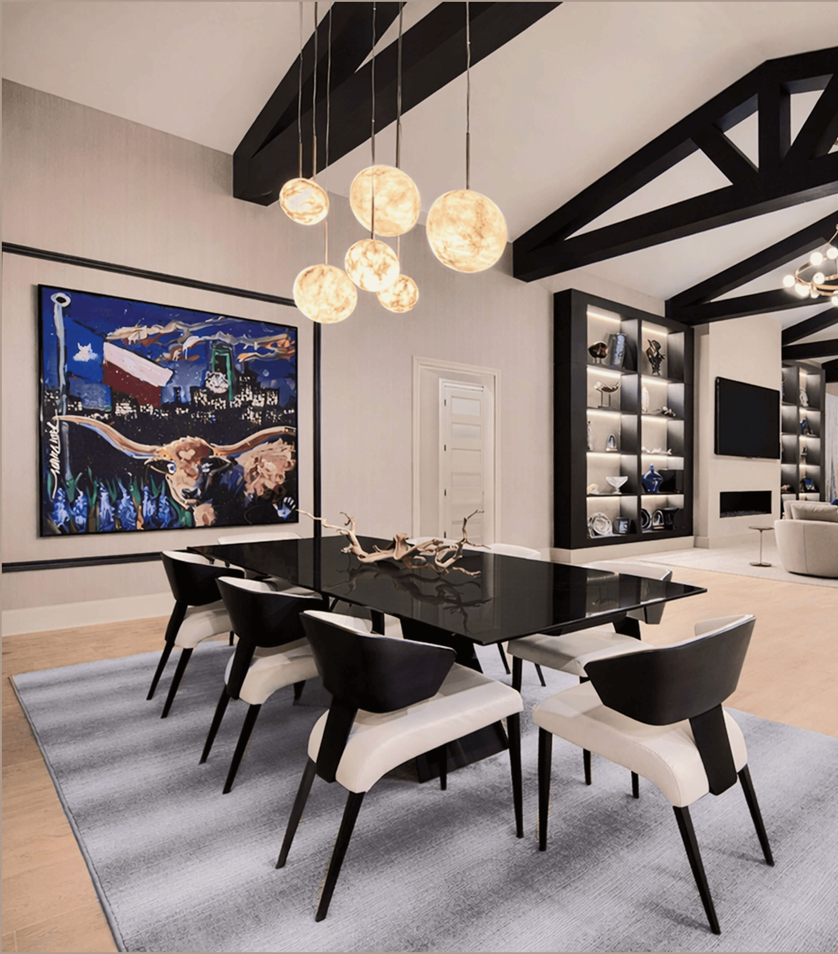 Elegant living room with white sectional, dark built-ins, brass chandelier, and framed abstract art.