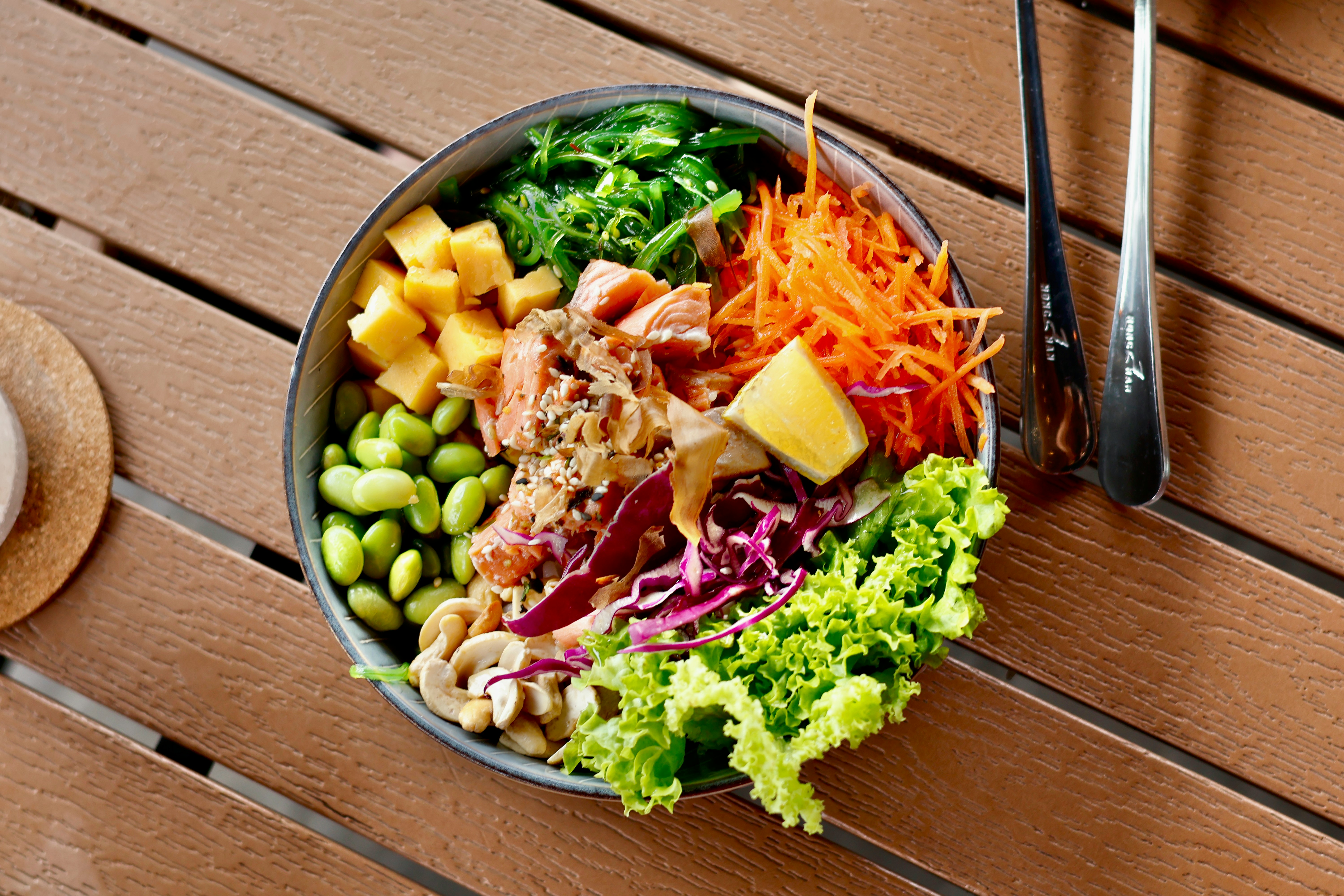 a bowl of food sitting on a wooden table