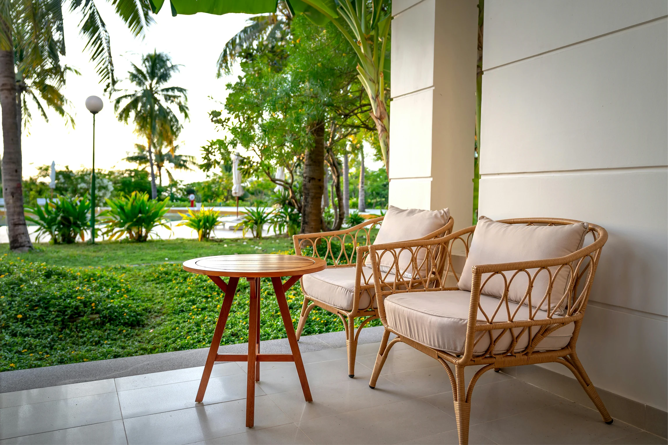 Private terrace of the garden twin room with outdoor chairs and views of the resort garden.