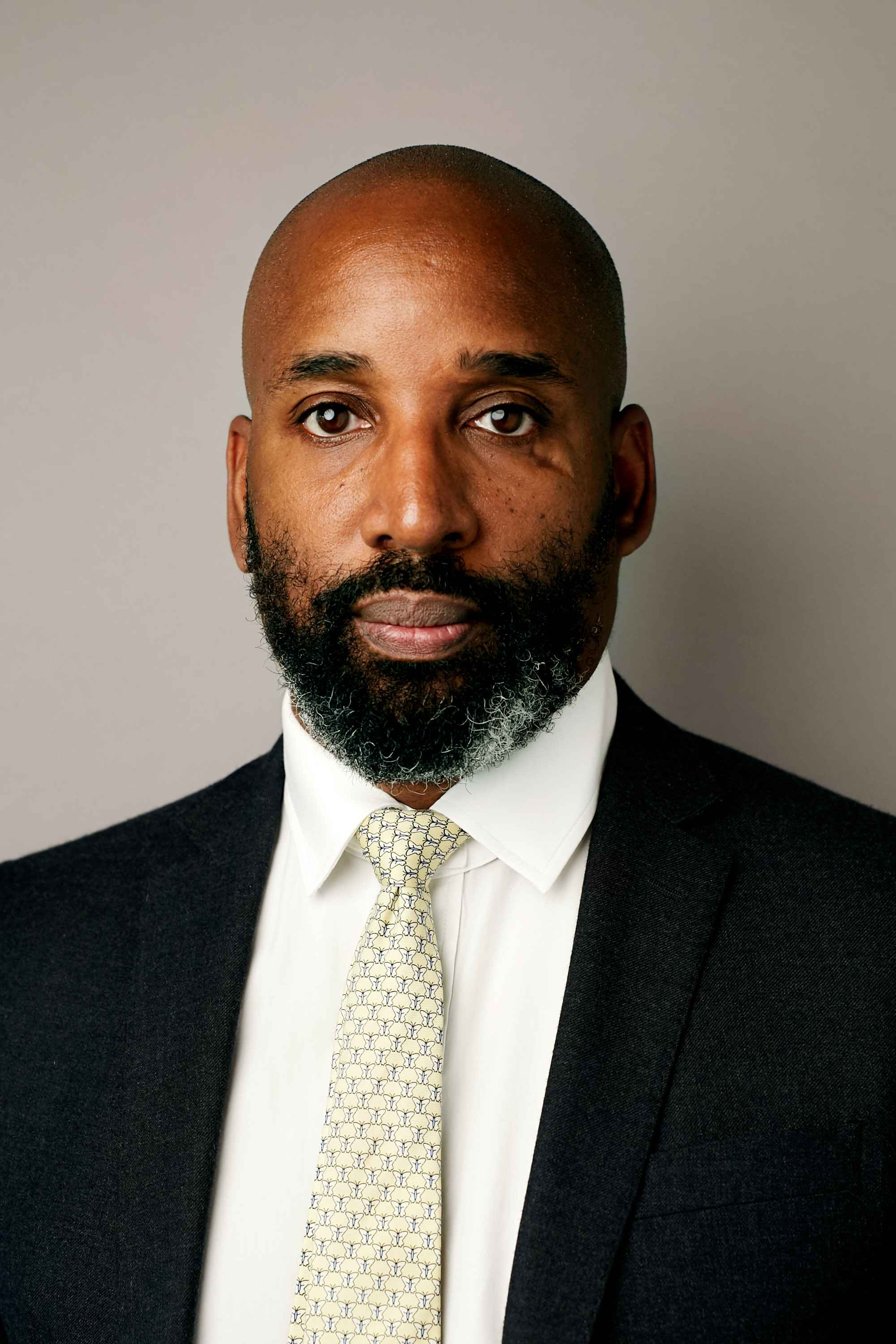 Man in a black suit and tie.