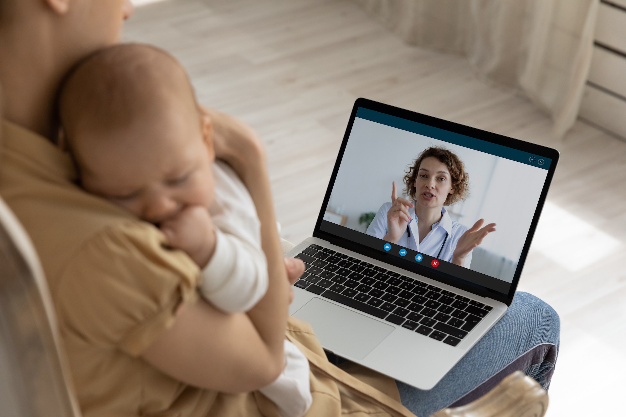 Mother and baby receiving telehealth care from A+P House Calls provider via laptop — virtual medical care on Long Island, NY