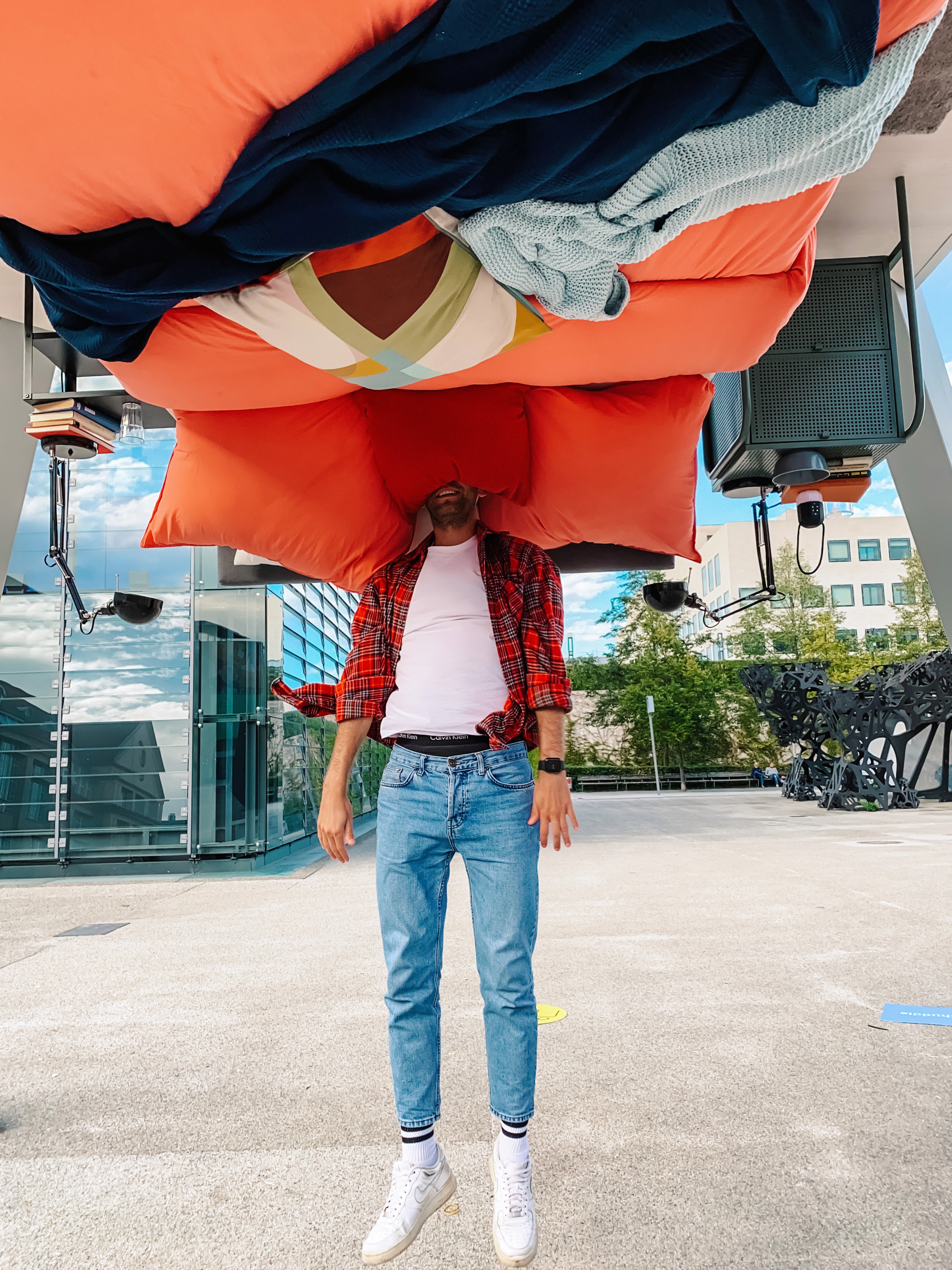 IKEA Karlsruhe net huddle campaign activation with a participant jumping into an upside-down bedroom installation inside a large public pyramid structure.