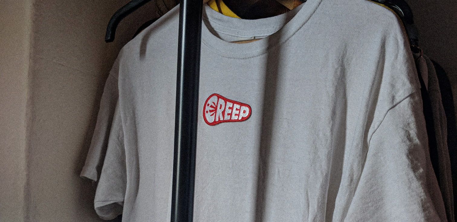 creep red mark on white t-shirt ion clothing rack.