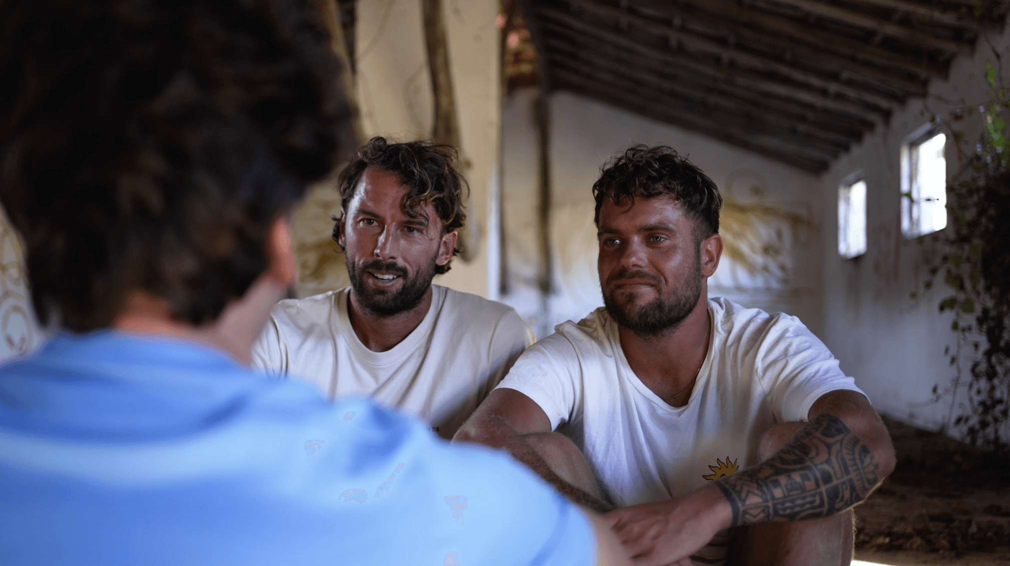 Men looking each other in the eyes after transformational breathwork