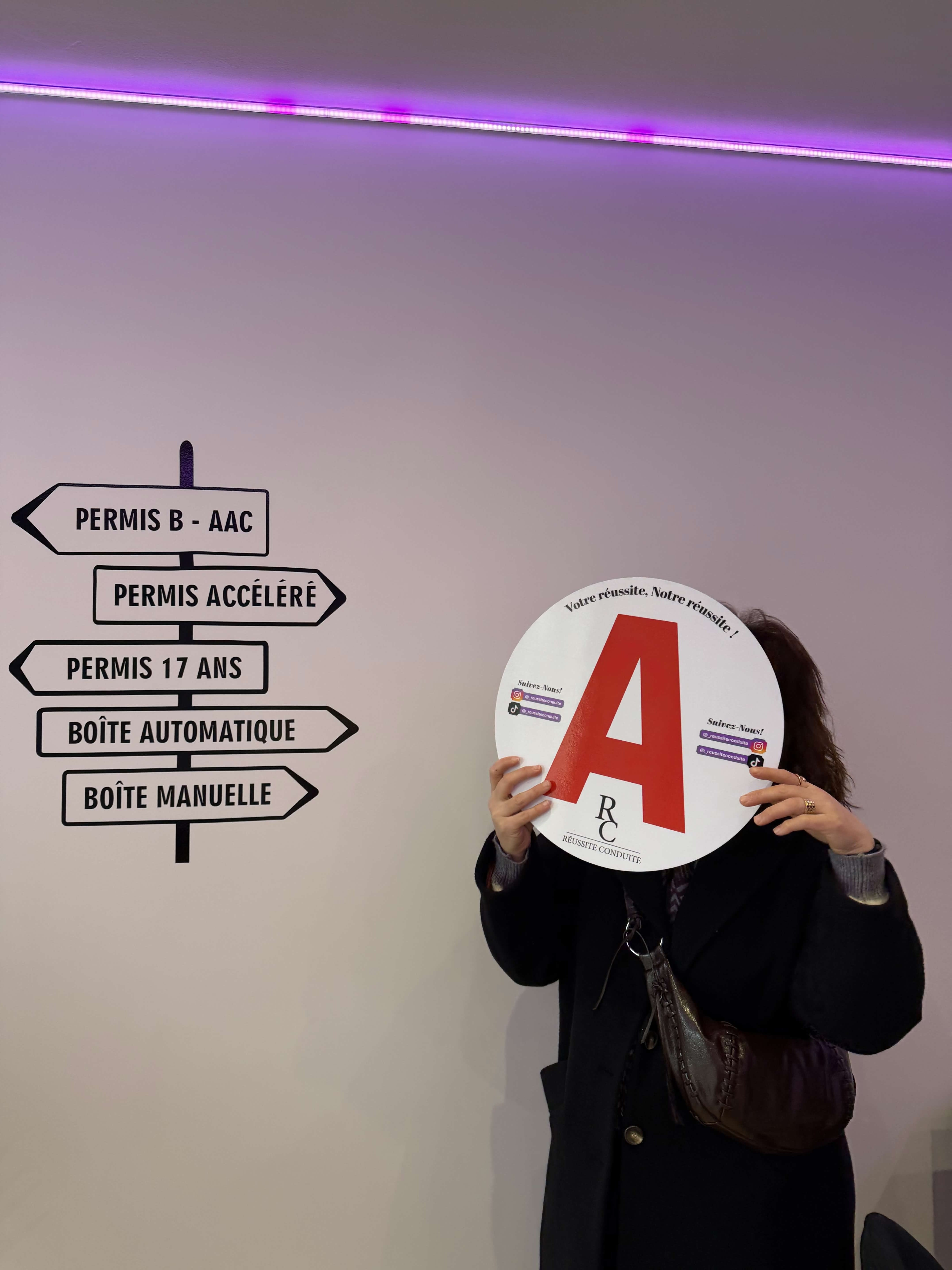 man in black jacket holding blue tablet computer