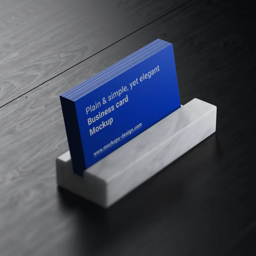 A blue business card displayed in a gray holder on a dark surface.