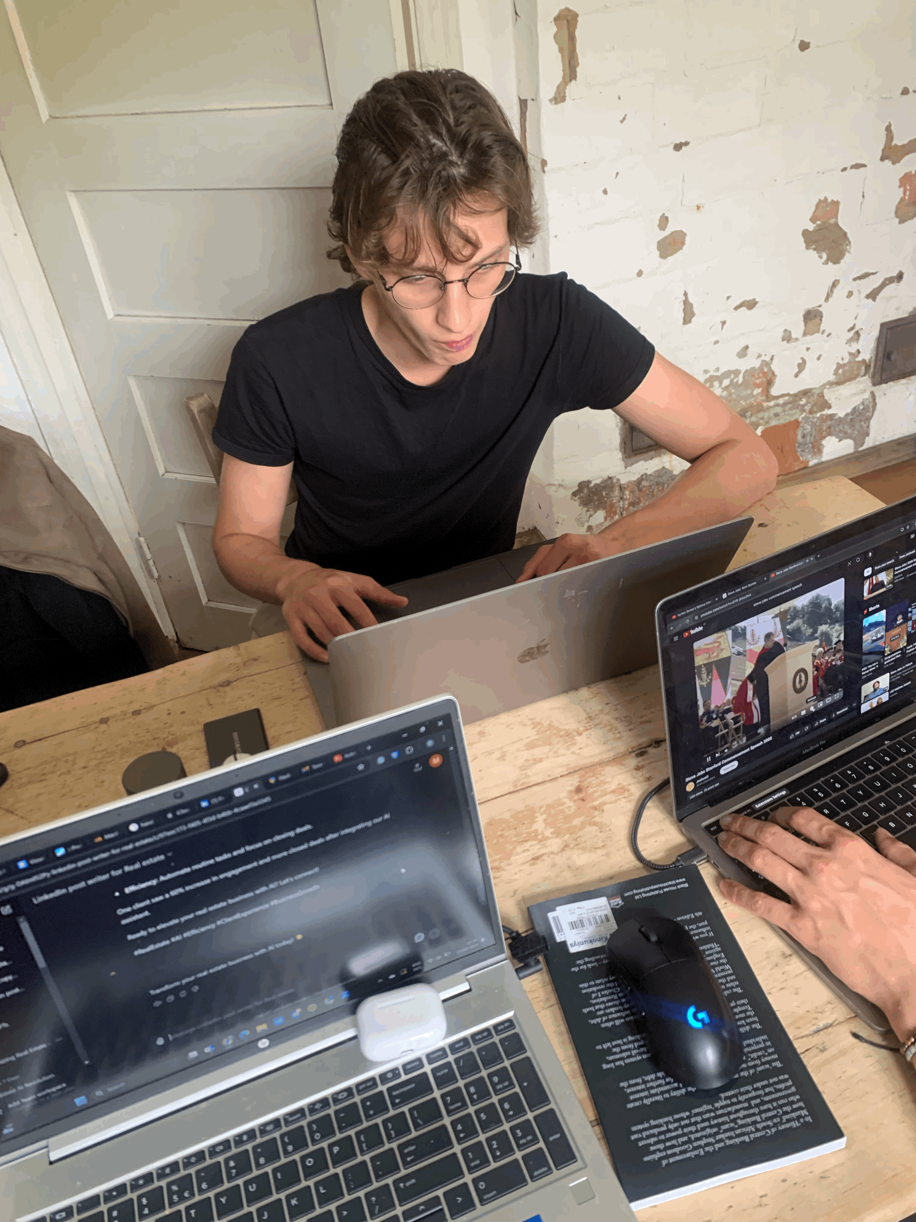 man sitting while having coffee and using laptop