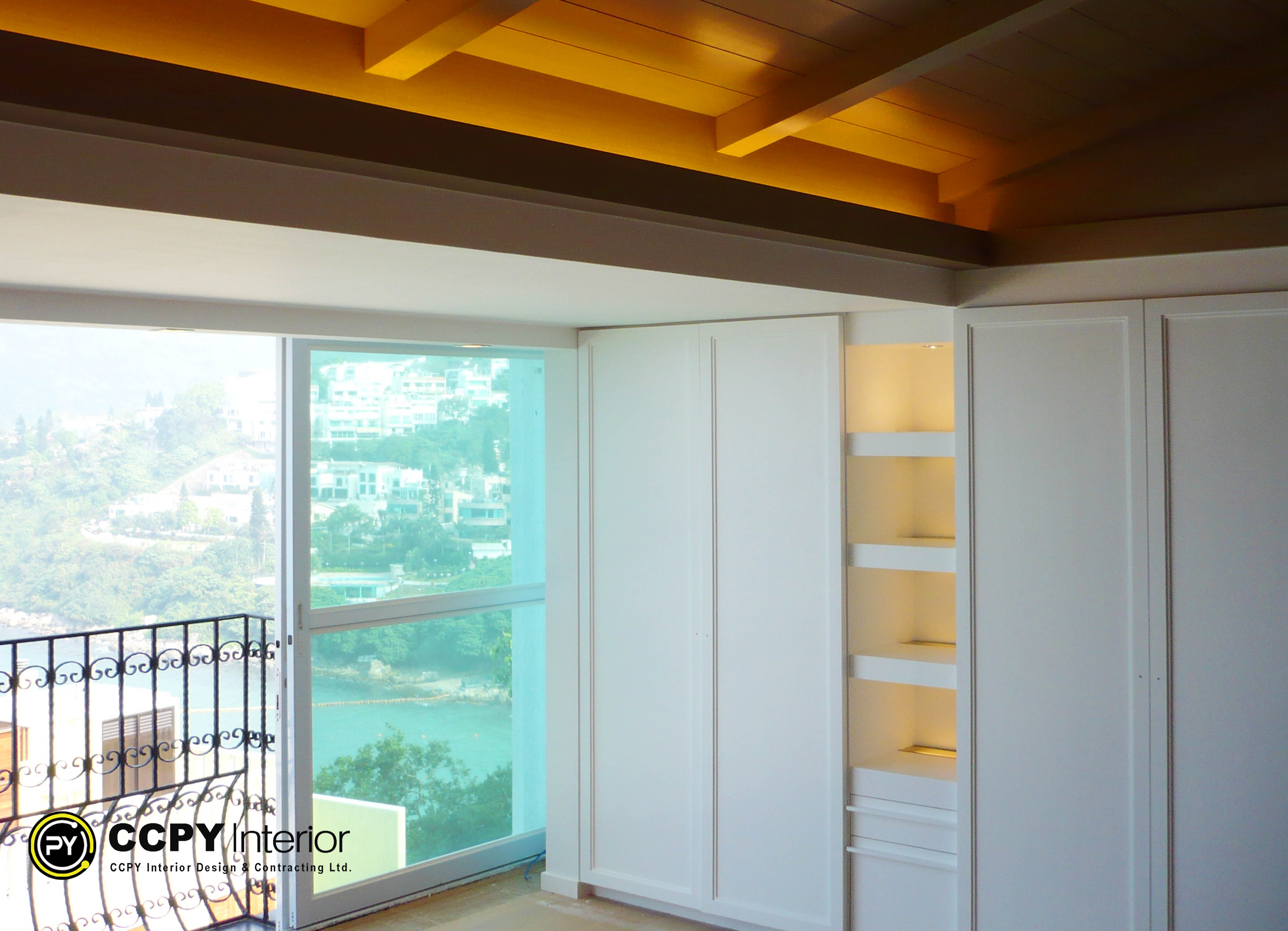 Luxurious hallway at Mount Pavilia 20 featuring built-in cabinetry, elegant wainscoting, and a dark wood console table beneath a vibrant piece of framed art.