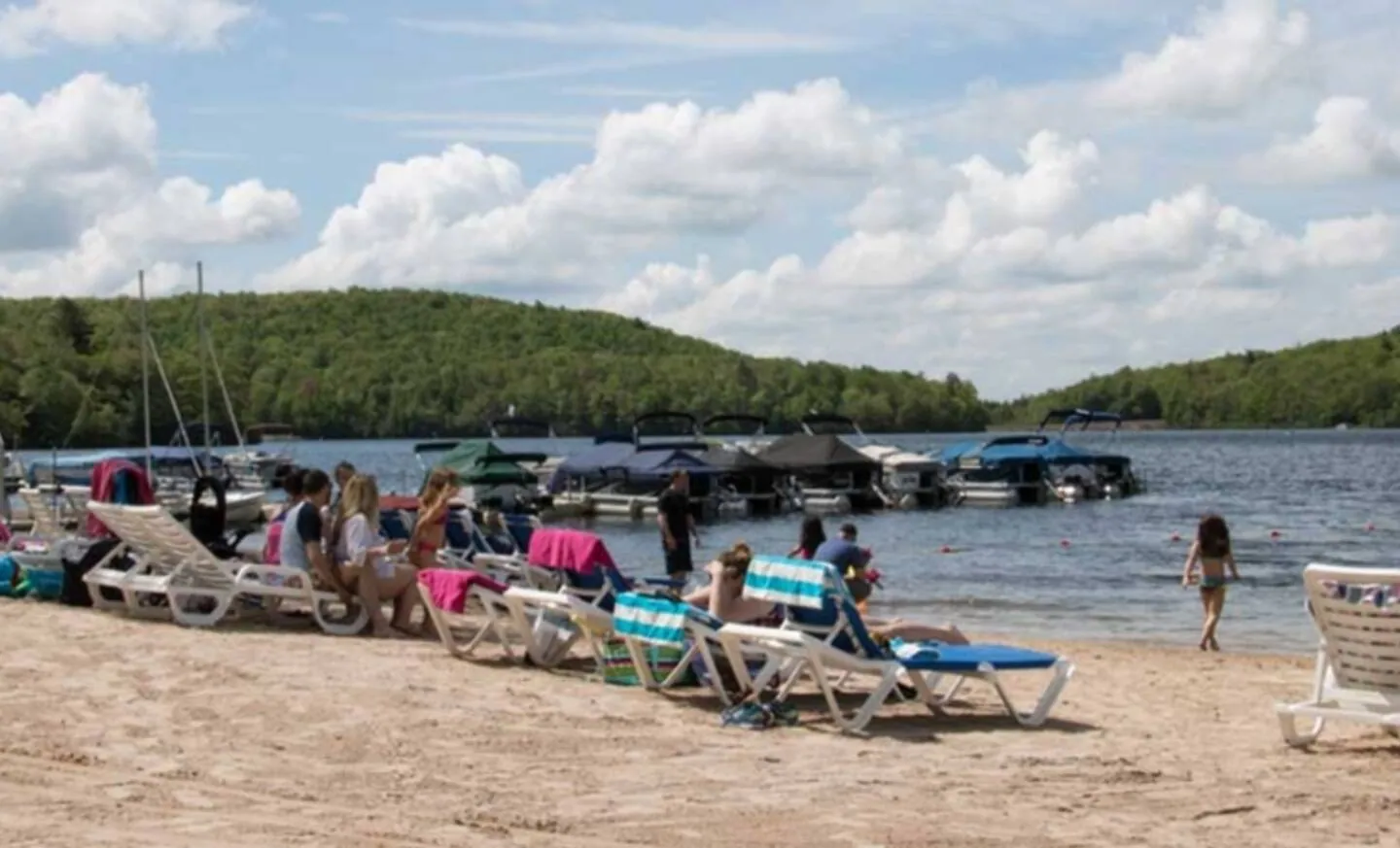 Boulder Lake Club beach with lounge chairs and boat docks, Big Boulder, Lake Harmony, PA
